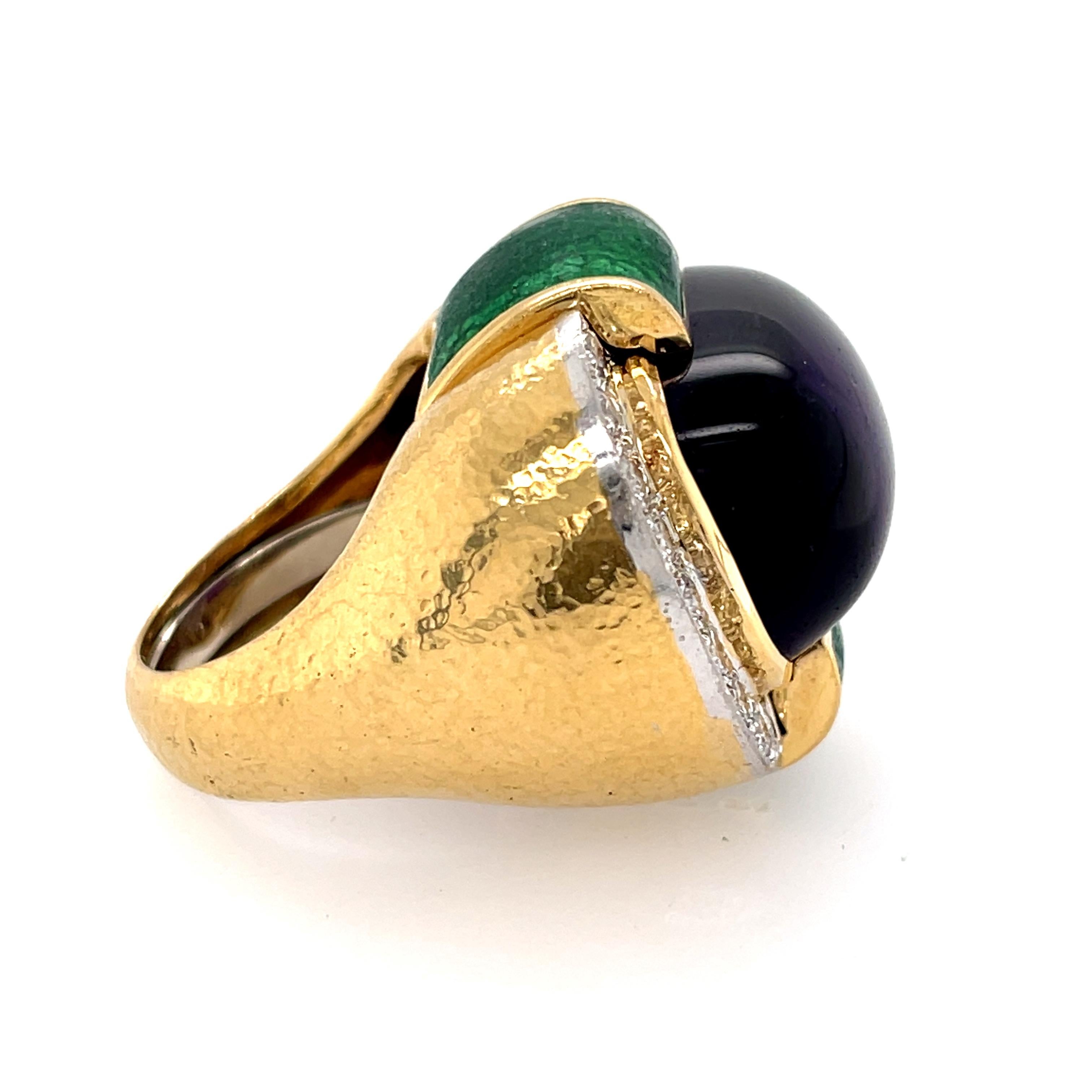 A vintage 18k gold and platinum cabochon amethyst, diamond, green enamel ring by David Webb. This colorful and vibrant ring is set with a rich amethyst. It is surrounded by round brilliant cut diamonds that weigh approximately 0.82 carats. The