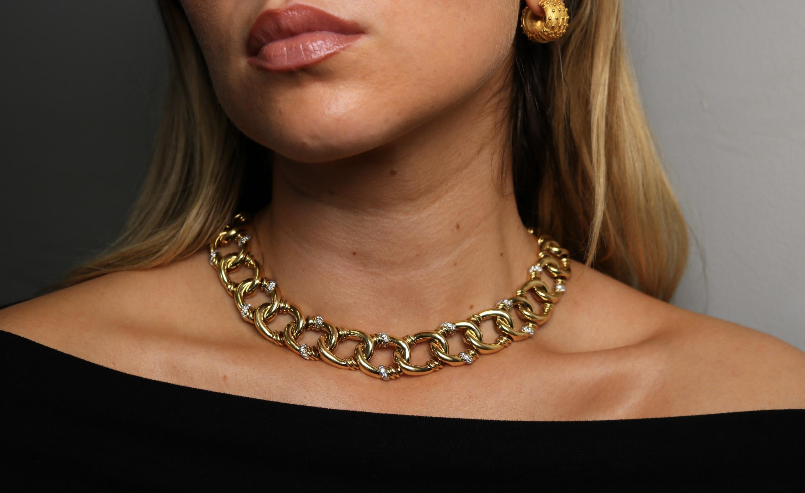 Vintage David Webb 18K Yellow Gold and Platinum Diamond Collar Necklace ~1.4ctw

This modern necklace by David Webb features a bold arrangement of interlocking gold links, each shaped with care to create a strong, sculptural design. Set between the