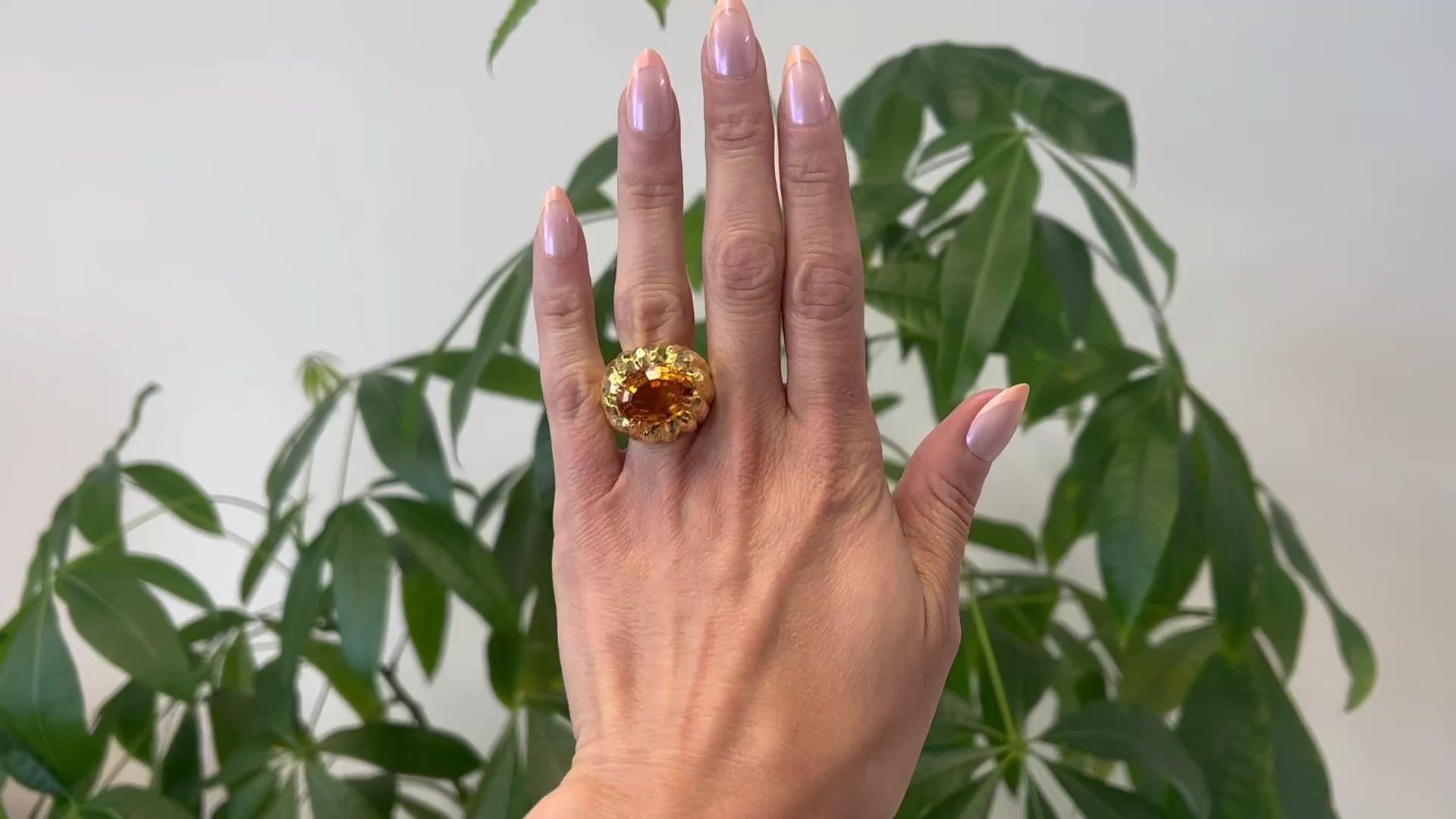 One Vintage David Webb Citrine 18k Yellow Gold Cocktail Ring. Featuring one oval mixed cut golden citrine weighing approximately 10.00 carats. Crafted in 18 karat yellow gold signed Webb with purity marks. Circa 1980. The ring is a size 6 ½ and