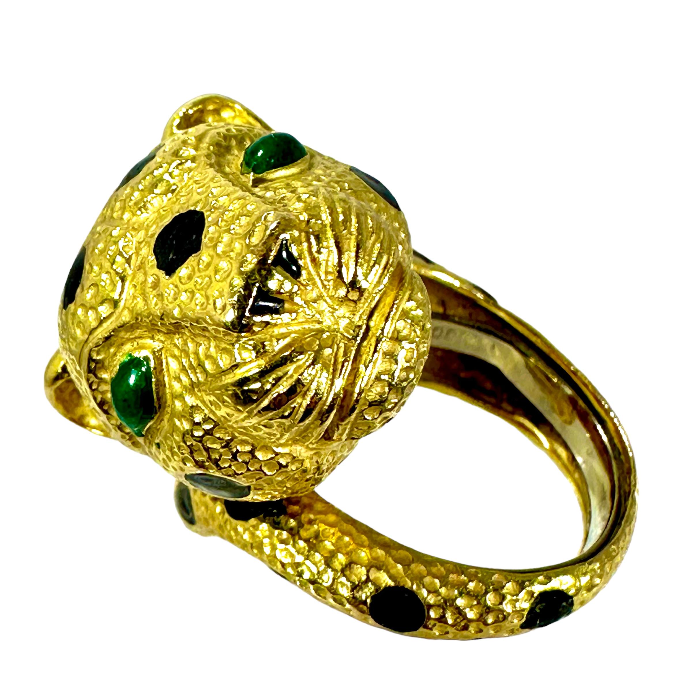 Made by David Webb in 18K yellow gold, this vintage, whimsical leopard ring is textured with Webb's signature, finely hammered finish. The black enamel spots and green enamel eyes complete the design.
The leopard's large head measures .81 inch wide