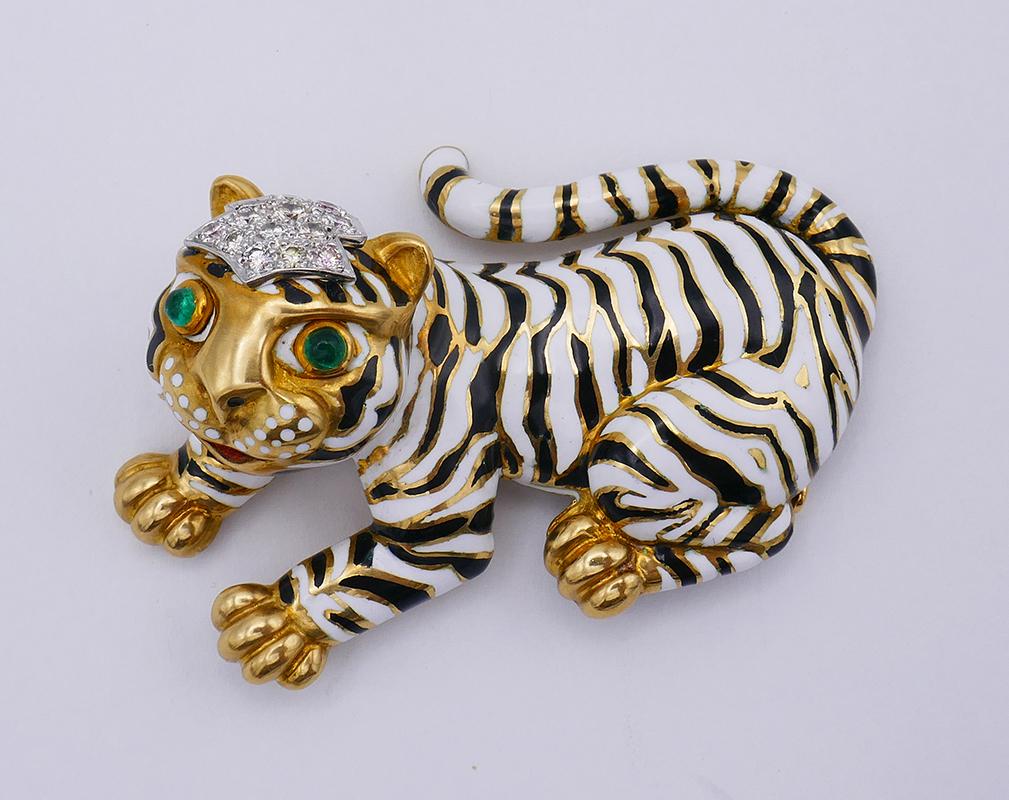 A cute vintage David Webb brooch in 18 karat yellow gold, featuring enamel and gemstones. 
Nature has been a constant source of inspiration for David Webb jewelry. This yellow gold and enamel tiger brooch is a great example of the iconic animalistic