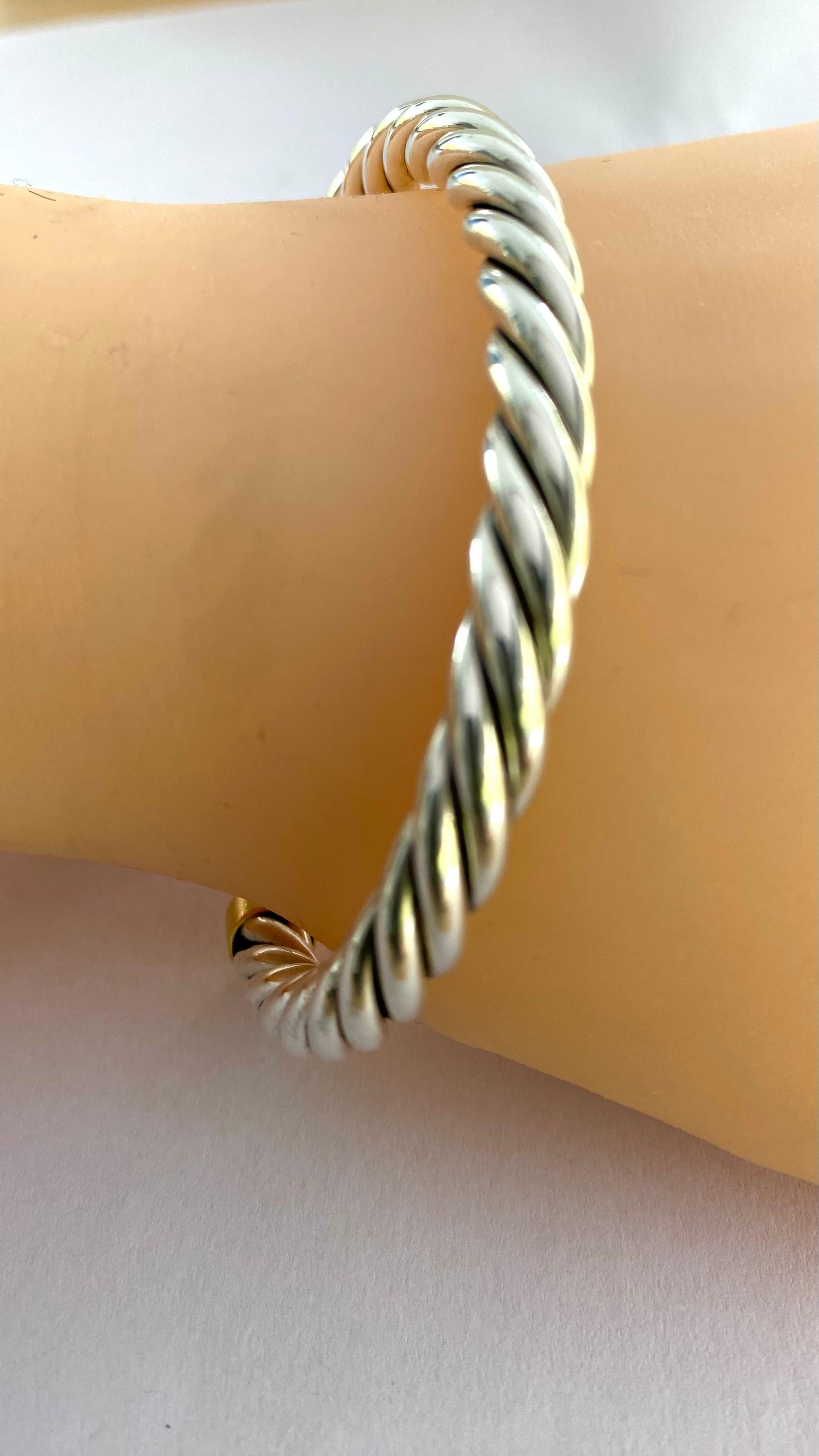 Indulge in the timeless elegance of this exquisite vintage David Yurman bracelet. Crafted in the 20th century, this piece exemplifies classic luxury with its intricate braided design. Meticulously constructed from premium sterling silver and