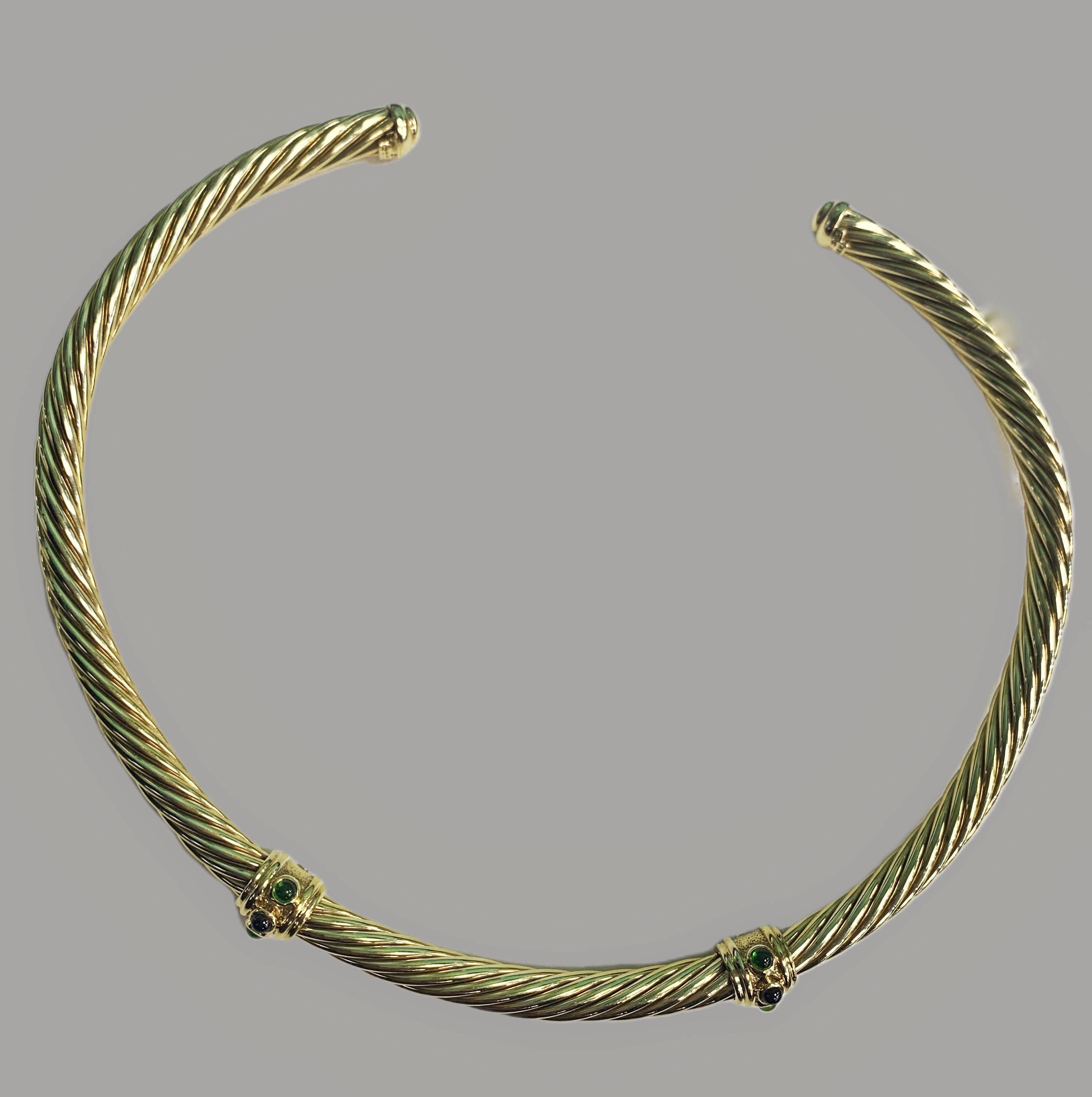 This beautiful David Yurman 14 Karat Yellow Gold Renaissance choker necklace was designed in their signature cable design. The choker necklace features two stations of alternating cabochon peridots with garnets. It is 7 millimeters in width and