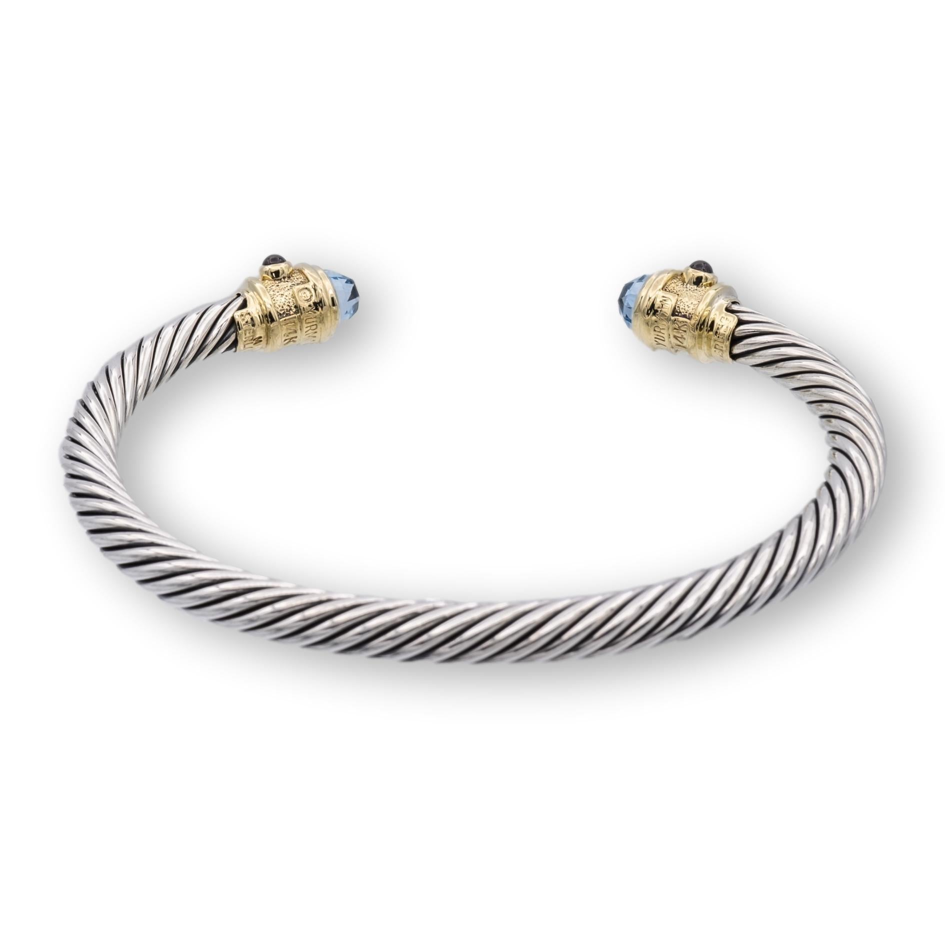 Vintage David Yurman bracelet from the Renaissance collection finely crafted in sterling silver featuring two 6mm round blue topaz cabochons medium blue in color located at each end set in 14K yellow gold accented by 6 pink tourmaline cabochon