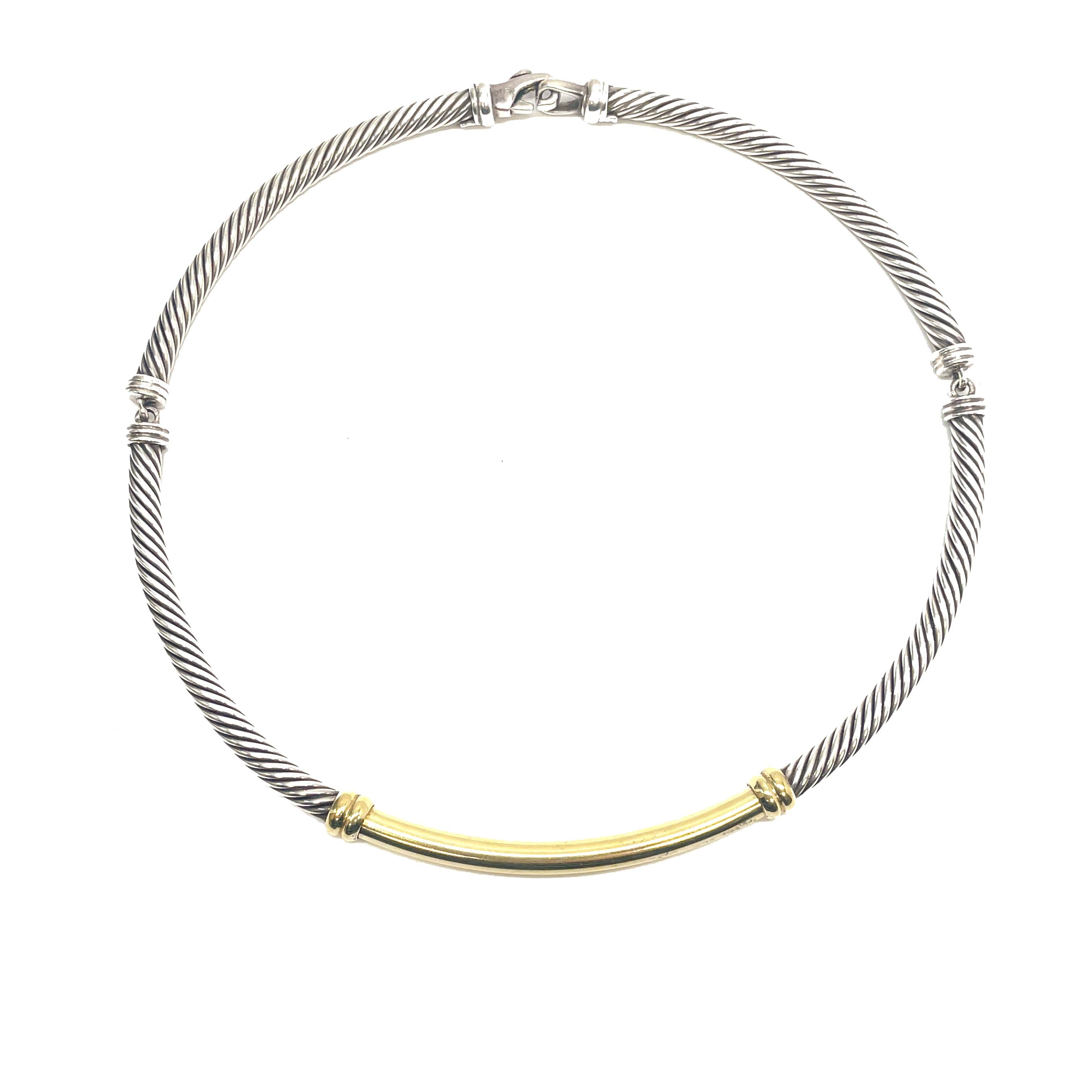 This is a gorgeous signed David Yurman vintage choker that is set in sterling silver that features a 14K yellow gold bar. 

This 90's Yurman necklace showcases a 7mm solid 14K yellow gold bar complimented by the iconic double twisted helix design