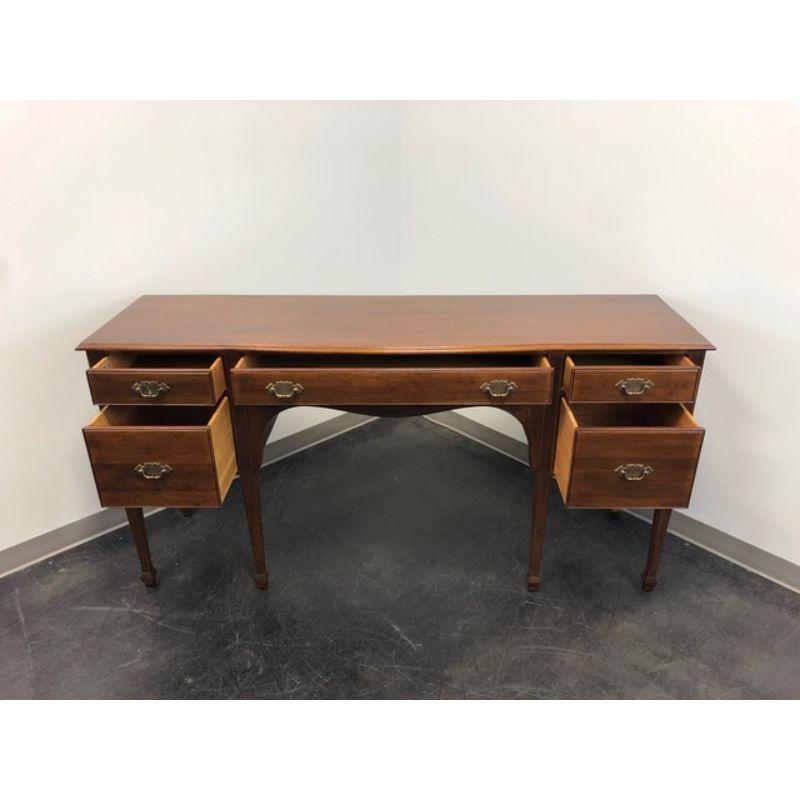 A sideboard in solid Mahogany by Davis Cabinet Company. Made in Nashville, Tennessee, USA in the late 20th Century. Five dovetail drawers with brass hardware. Federal style with fluted columns and spade feet. 

Style #:  2290, Windsor Mahogany