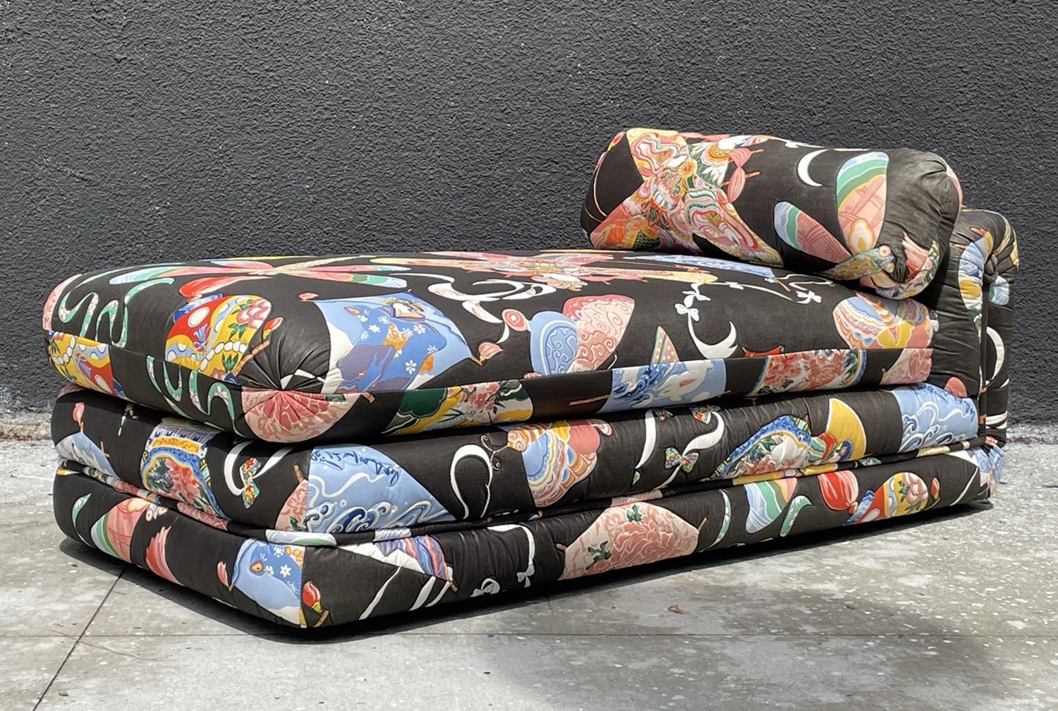 Introducing our exquisite Vintage Day Bed with Asian Themed Upholstery, a treasure from the USA in the 1960s. This stunning piece of furniture boasts a timeless charm that effortlessly blends vintage allure with the captivating beauty of