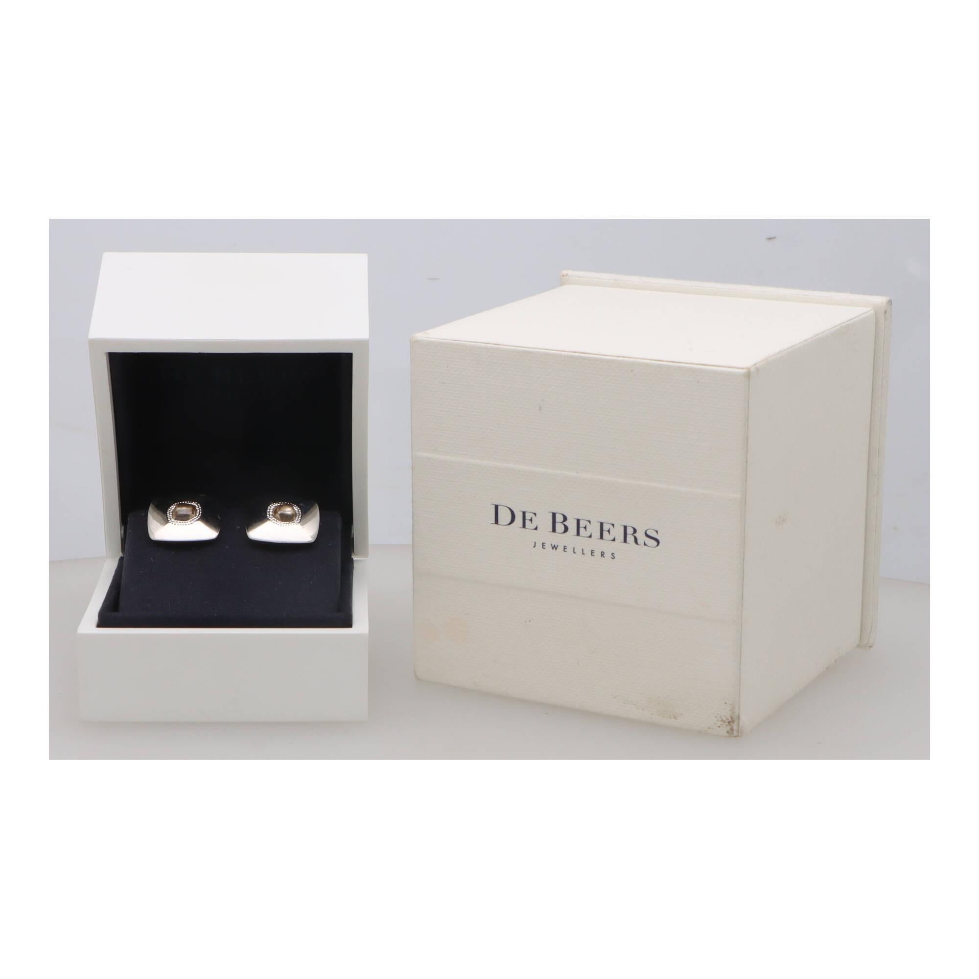 A unique pair of vintage De Beer ‘Talisman’ rough diamond bar cufflinks set in 18k white gold.

From a now discontinued collection, each cufflink is composed of a cushion shaped white gold plaque, set to the centre with a highly unique rough