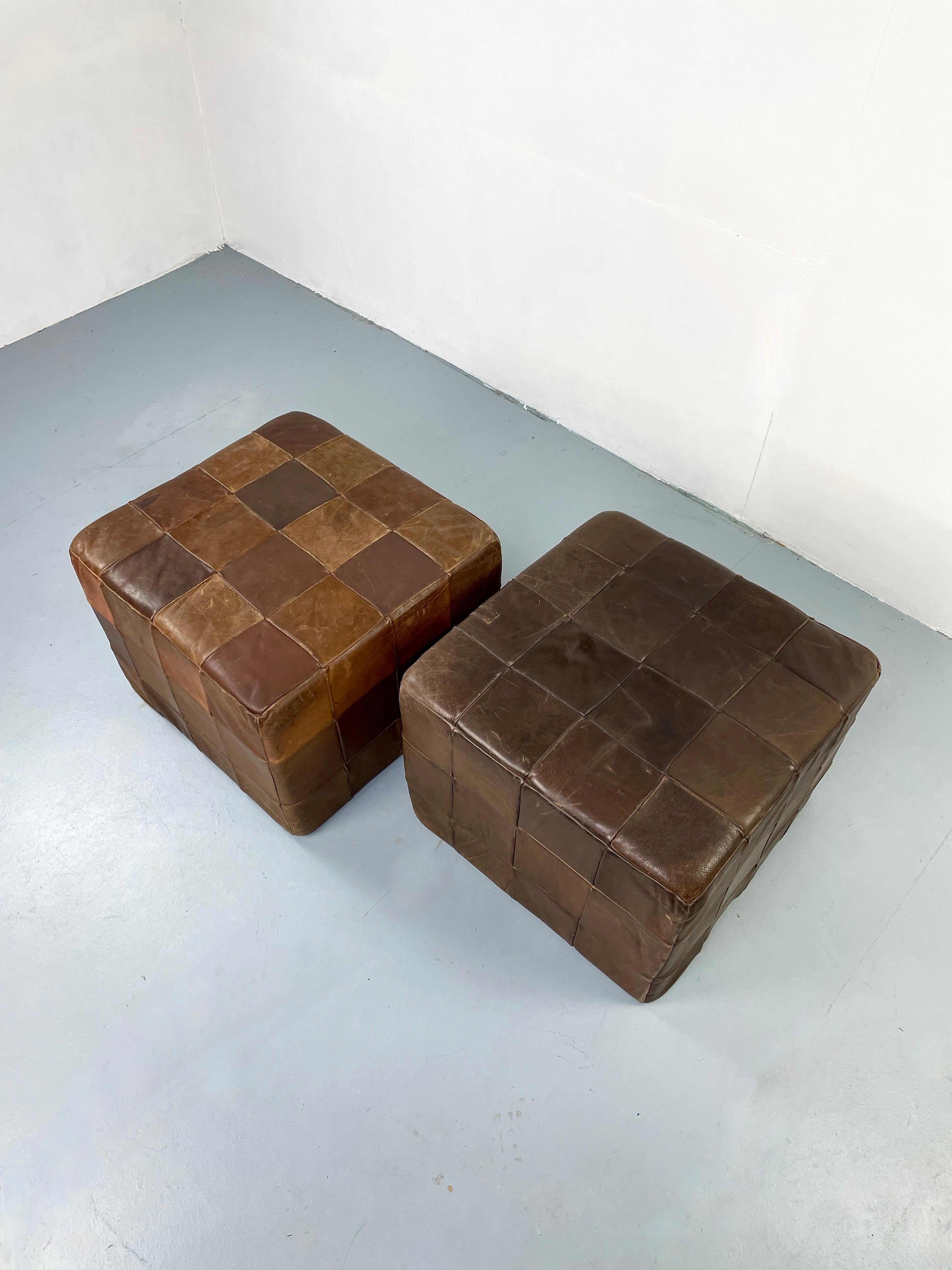 Pair of Rare large cube ottomans by De Sede in brown patchwork leather. 

Very soft high quality leather with great coloring and beautiful patina.

Produced in Switzerland. 
Great accent piece.