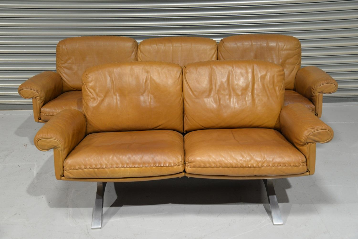 We are delighted to bring to you a highly desirable and rarely available matching pair of De Sede DS 31 sofas in beautiful soft tan aniline leather with superb whipstitch edge detail. The extremely comfortable vintage sofa and loveseat were built