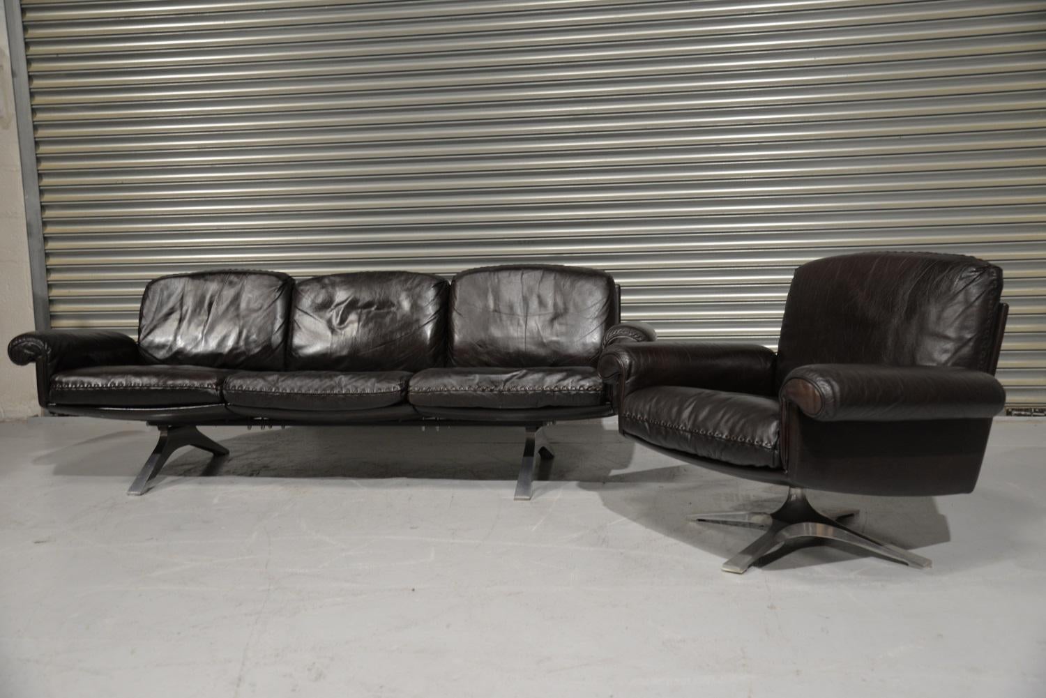 We are delighted to bring to you a Vintage de Sede DS 31 three-seat sofa and swivel lounge armchair. Built in the 1970s by De Sede craftsman from Switzerland these pieces are in beautiful soft dark aniline leather with superb whipstitch edge detail.