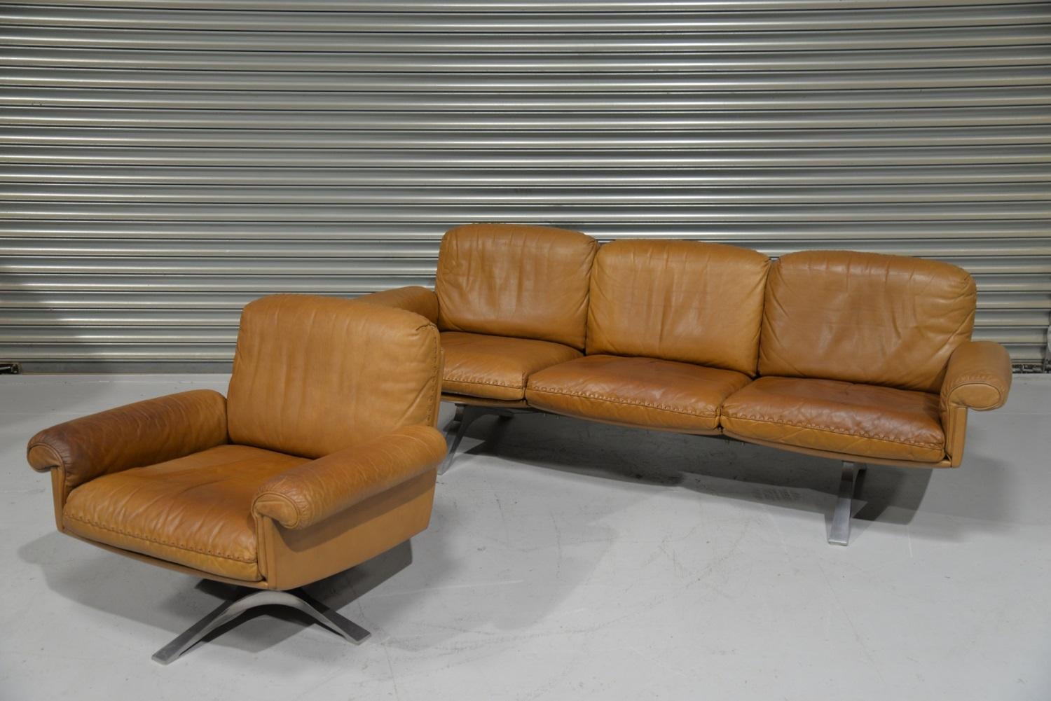 Discounted airfreight for our US and International customers ( from 2 weeks door to door)

A vintage De Sede DS 31 three-seat sofa and matching swivel lounge club armchair. This vintage sofa and matching swivel club armchair were built in the