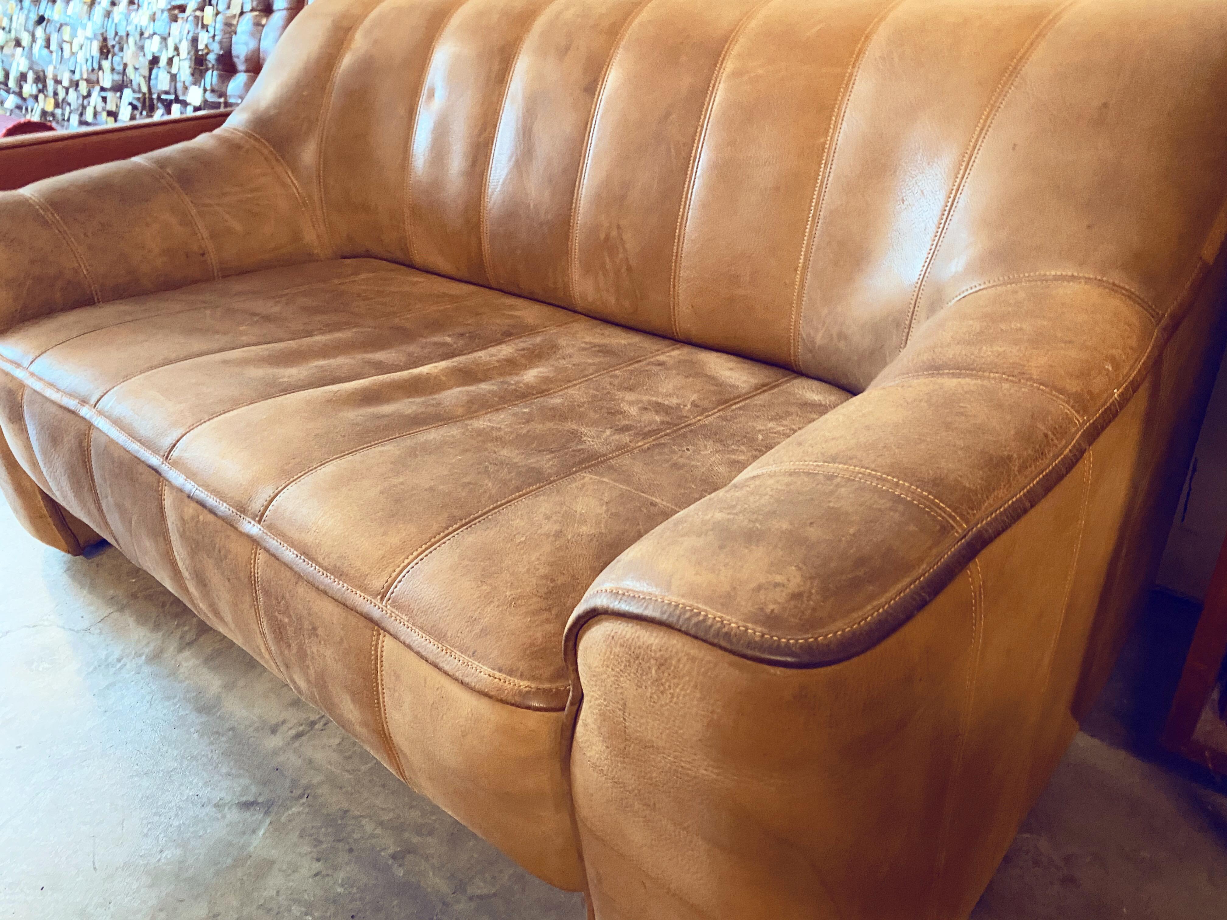 This vintage De Sede DS-44 buffalo leather adjustable love seat sofa is in overall good condition and wear consistent with age and use.  Gorgeous brown and thick, heavy, quality channel-tufted aged buffalo leather.  An adjustable seat that extends
