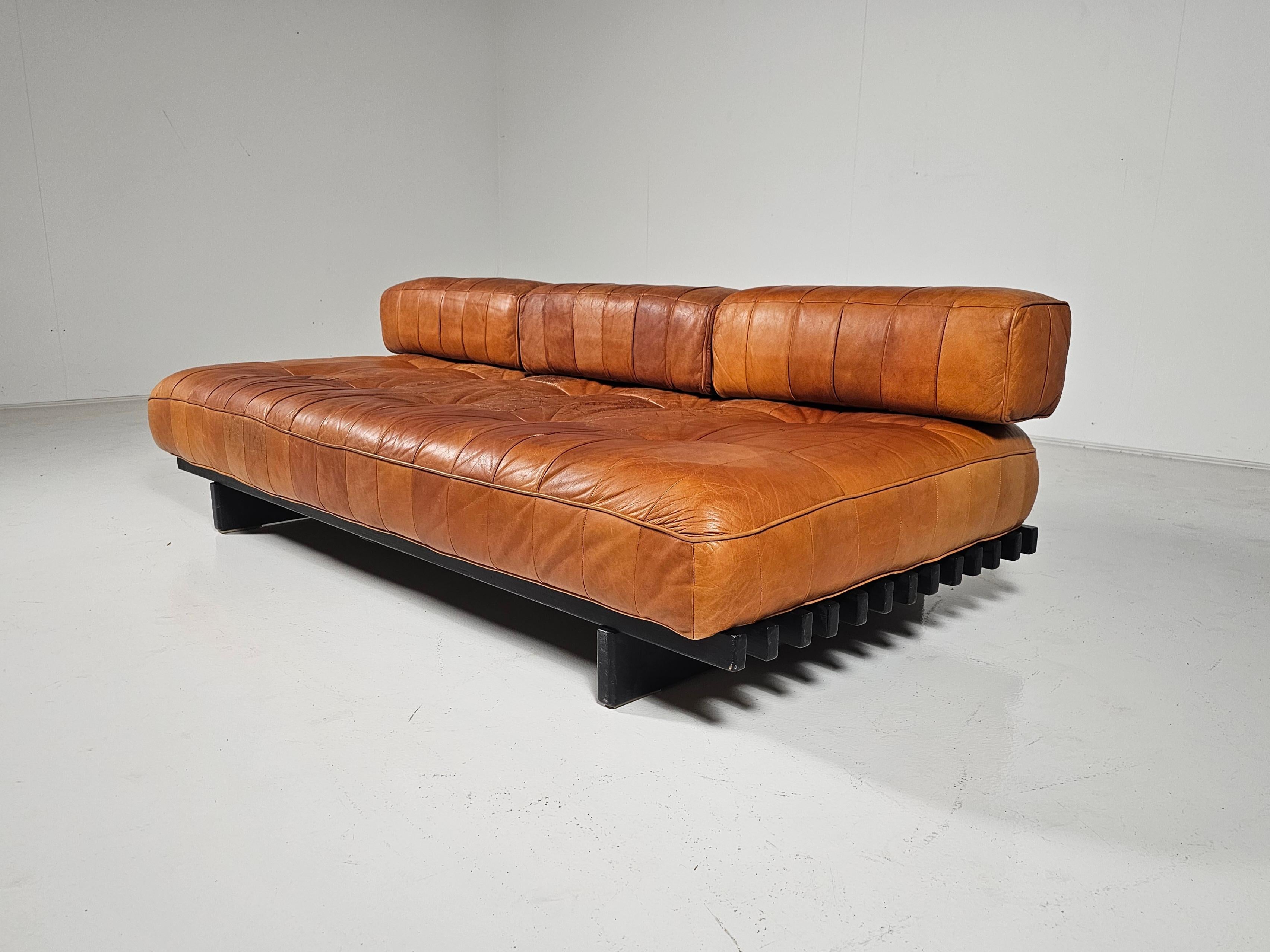 De Sede DS80 cognac leather patchwork daybed, Switzerland, 1970. Upholstered in its beautiful and soft original aniline leather with amazing wear.

The DS-80 sofa unites all of the characteristics of De Sede‘s furniture. Excellent manufacturing