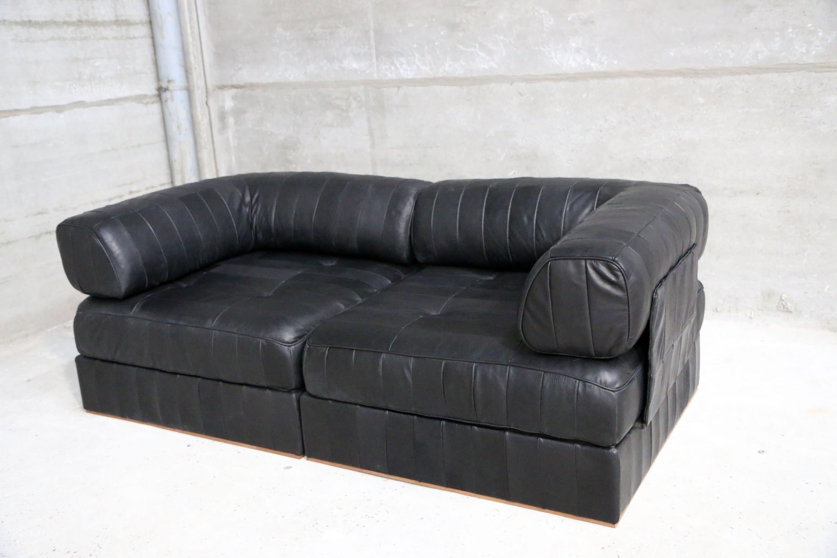Iconic DS88 modular patchwork sofa restored in our signature vintage aniline black leather. New foam and new leather. You can play with the modular composition of the sofa.
See pictures for dimensions and how its build up or