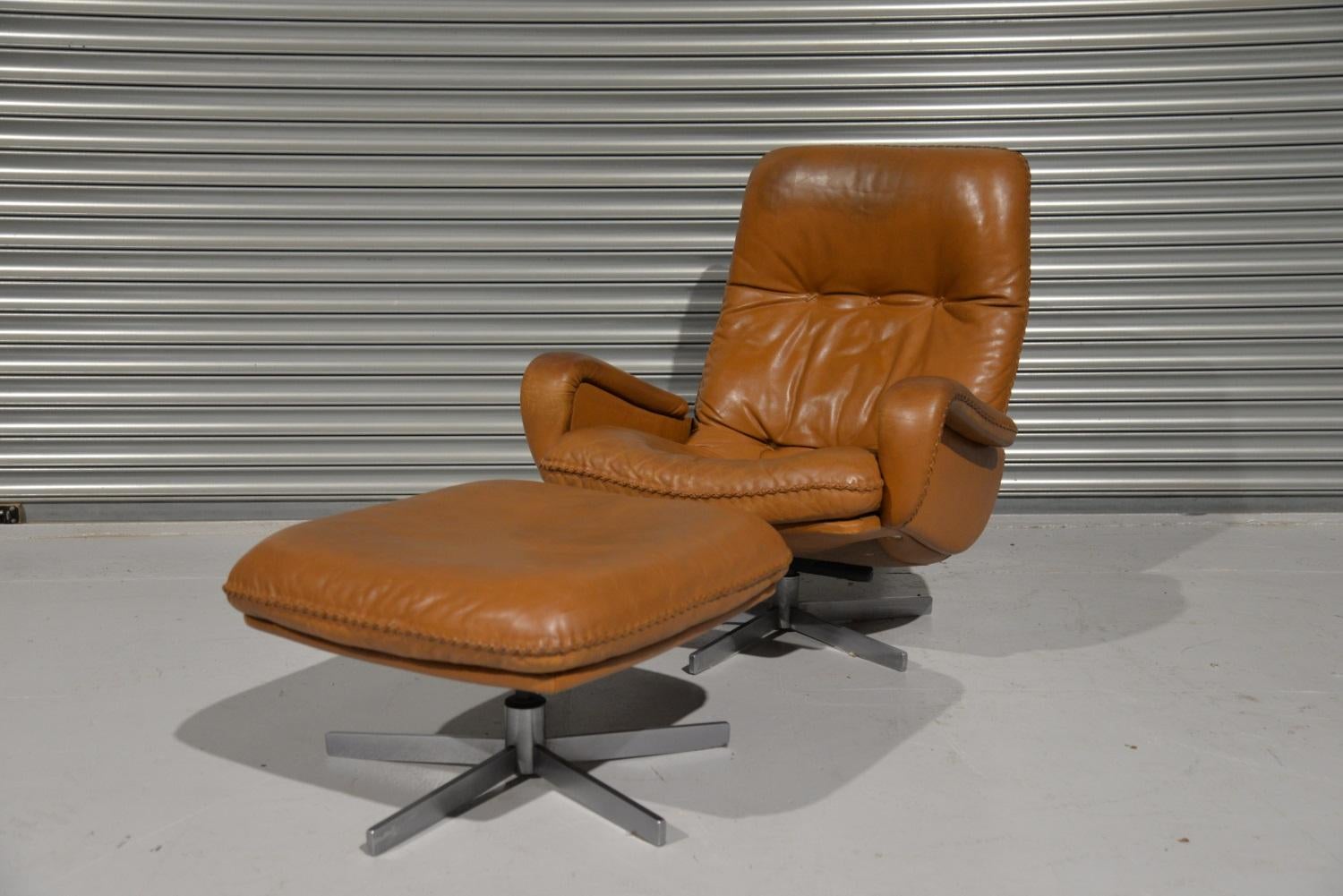 We are delighted to bring to you an ultra-rare and highly desirable De Sede S 231 vintage lounge swivel armchair and ottoman. Built in the late 1960s by De Sede craftsman from Switzerland this same chair was used as a prop in the 1969 James Bond