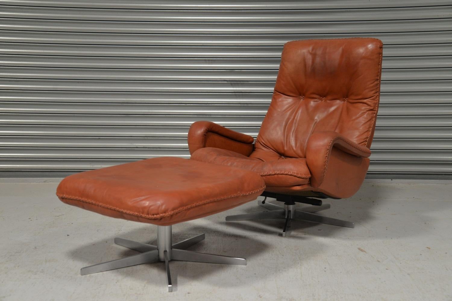 We are delighted to bring to you an ultra-rare and highly desirable De Sede S 231 vintage leather swivel armchair and ottoman. Built in the late 1960s by De Sede craftsman from Switzerland this same chair was used as a prop in the 1969 James Bond