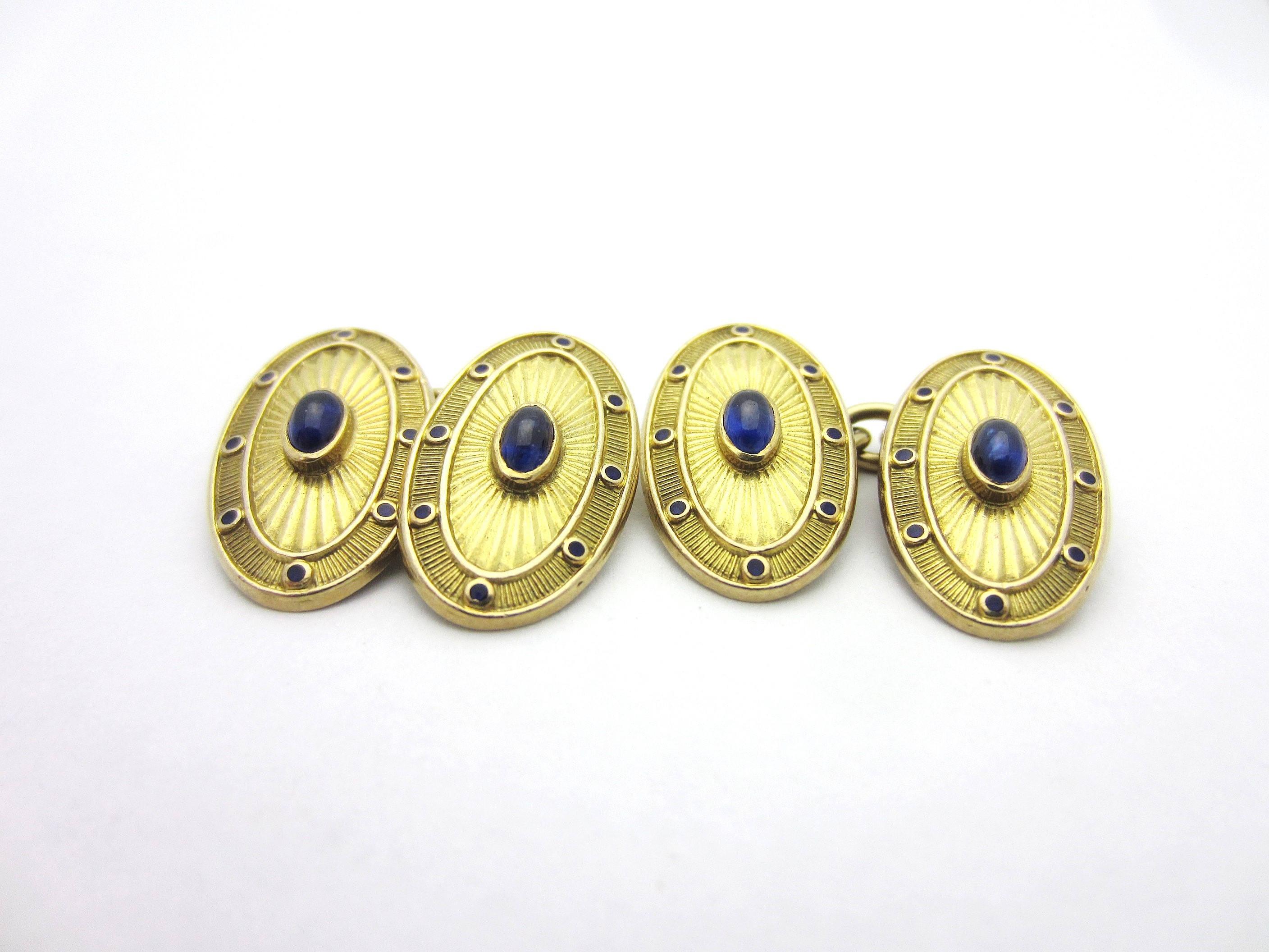 These incredible cufflinks by luxury British design house Deakin and Francis are a window into history.
This vintage pair of 18k yellow gold double-sided cufflinks features an oval face containing a natural blue sapphire cabochon. The gemstones are