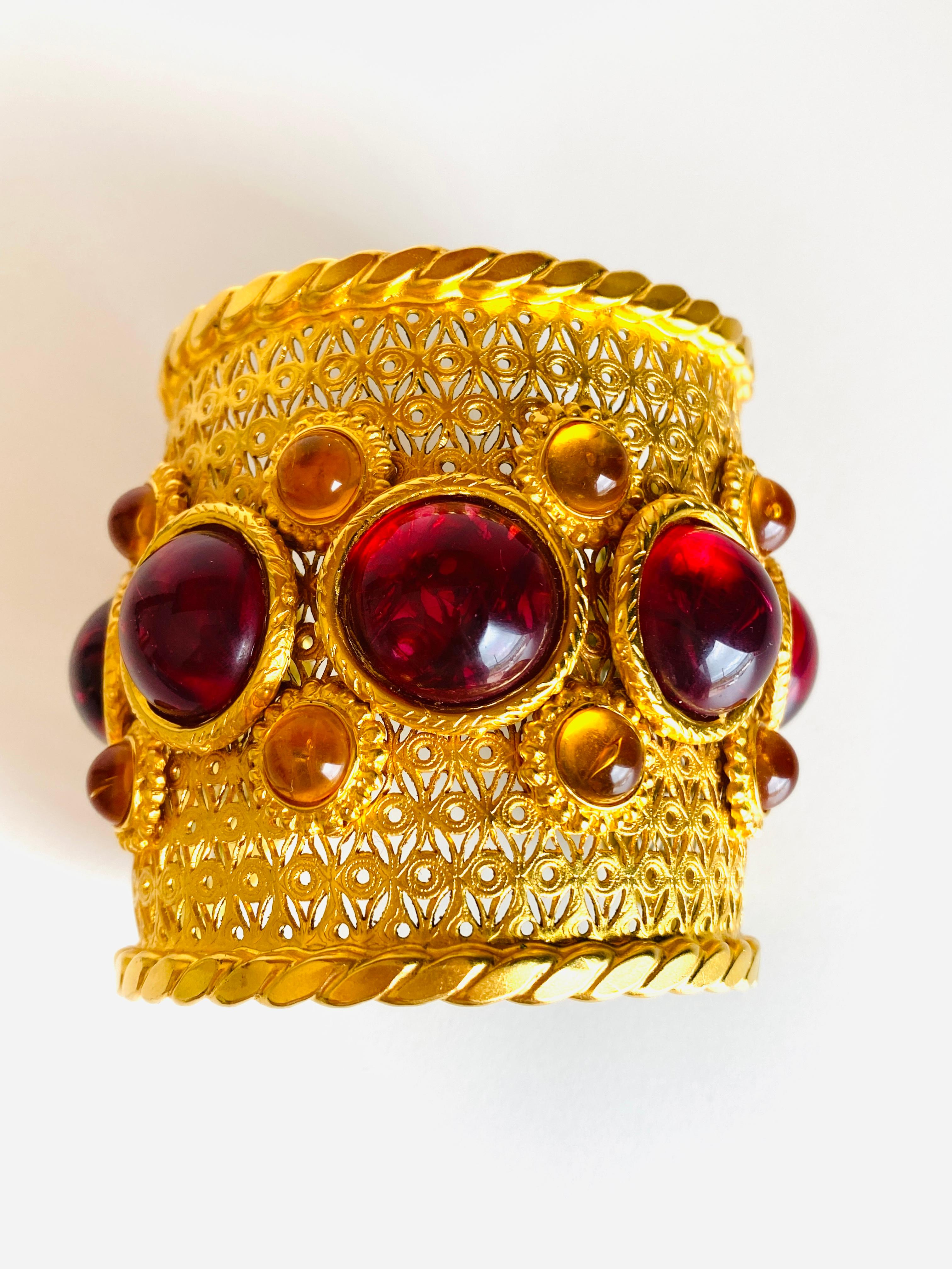 1980's Deanna Hamro cuff bracelet featuring bold red and gold pate de verre cabochons.

Width: 2-5/8