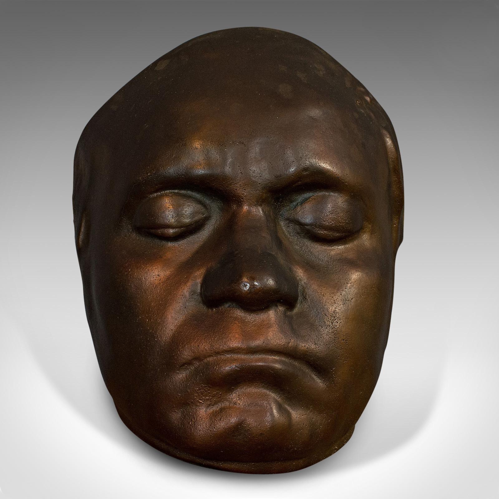 This is an vintage death mask. An English, bronze cast memento mori, dating to the 20th century, circa 1960.

Fascinating later example of the popular Victorian practice
Displays a desirable aged patina
Superb copper colouration to the cast