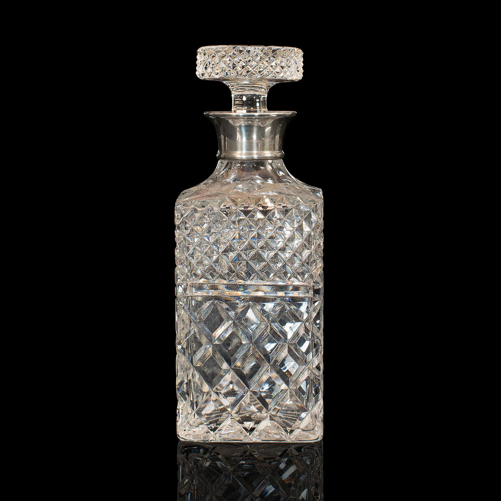 This is a vintage decanter. An English, cut glass and silver collared flask with London hallmark, dating it to the late 20th century, 1971.

Striking decanter with a superb stopper
Displays a desirable aged patina
Cut glass in good order