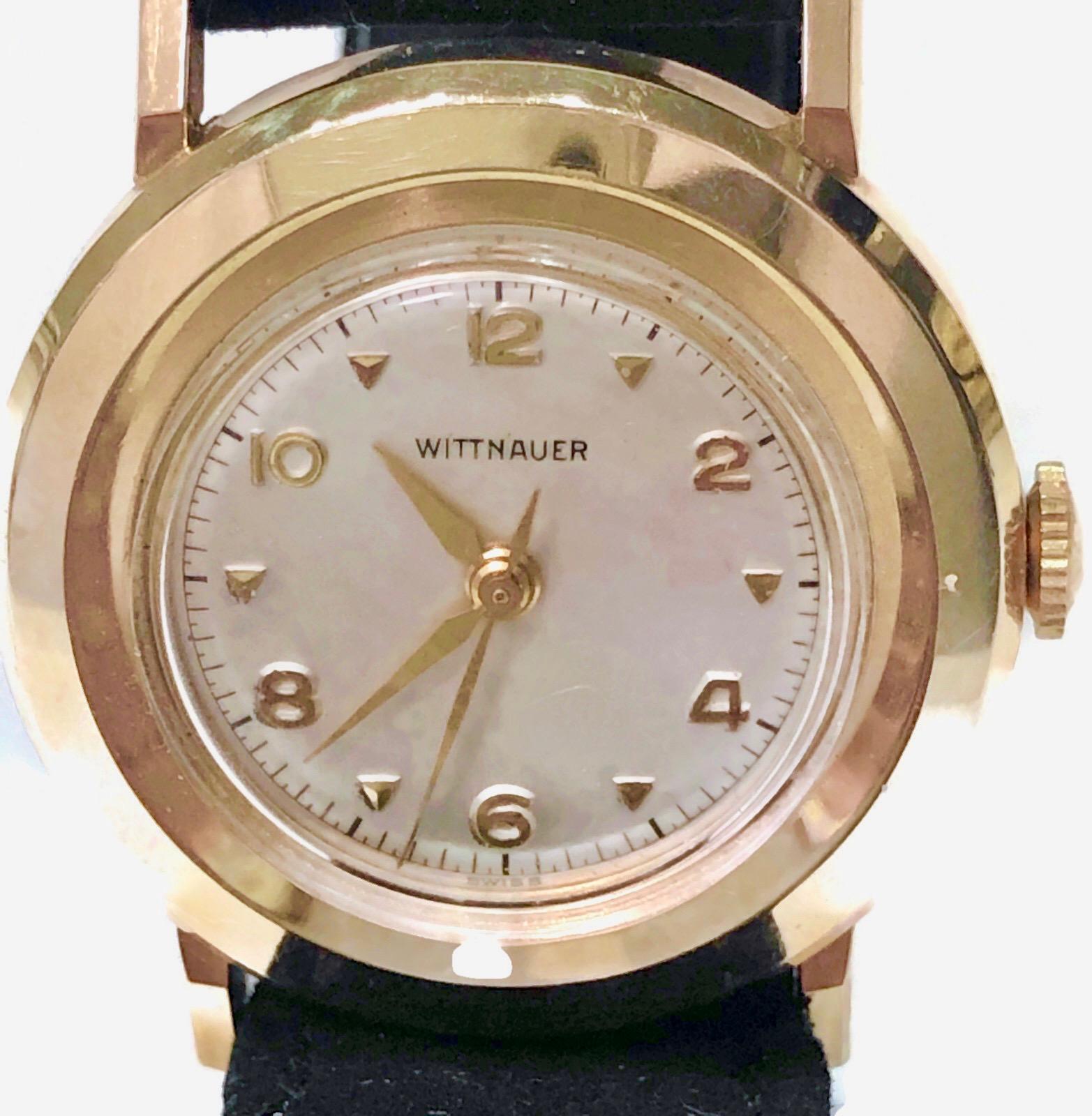 Vintage Wittnaur 14k yellow gold  watch with a round face and an automatic movement.  The watch is in the Art Deco style with an original black suede band with a 14k gold buckle.. 

The watch is in mint condition; the band is quite usable  The band