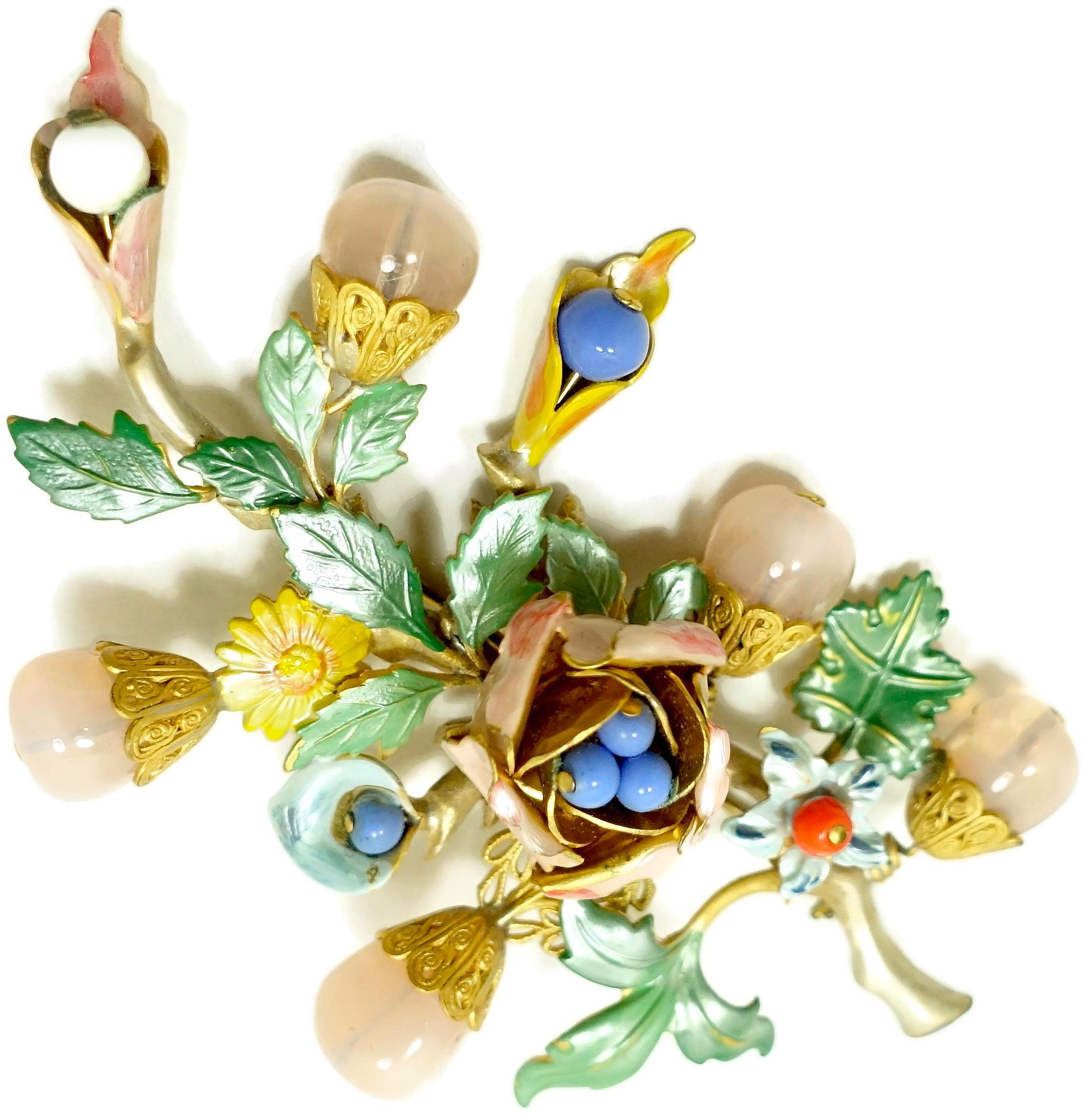 This vintage 1930s brooch has a floral design with multi-color enameling and bead accents in a gold tone setting.  In excellent condition, the brooch measures 3-3/4” x 2-1/2”.