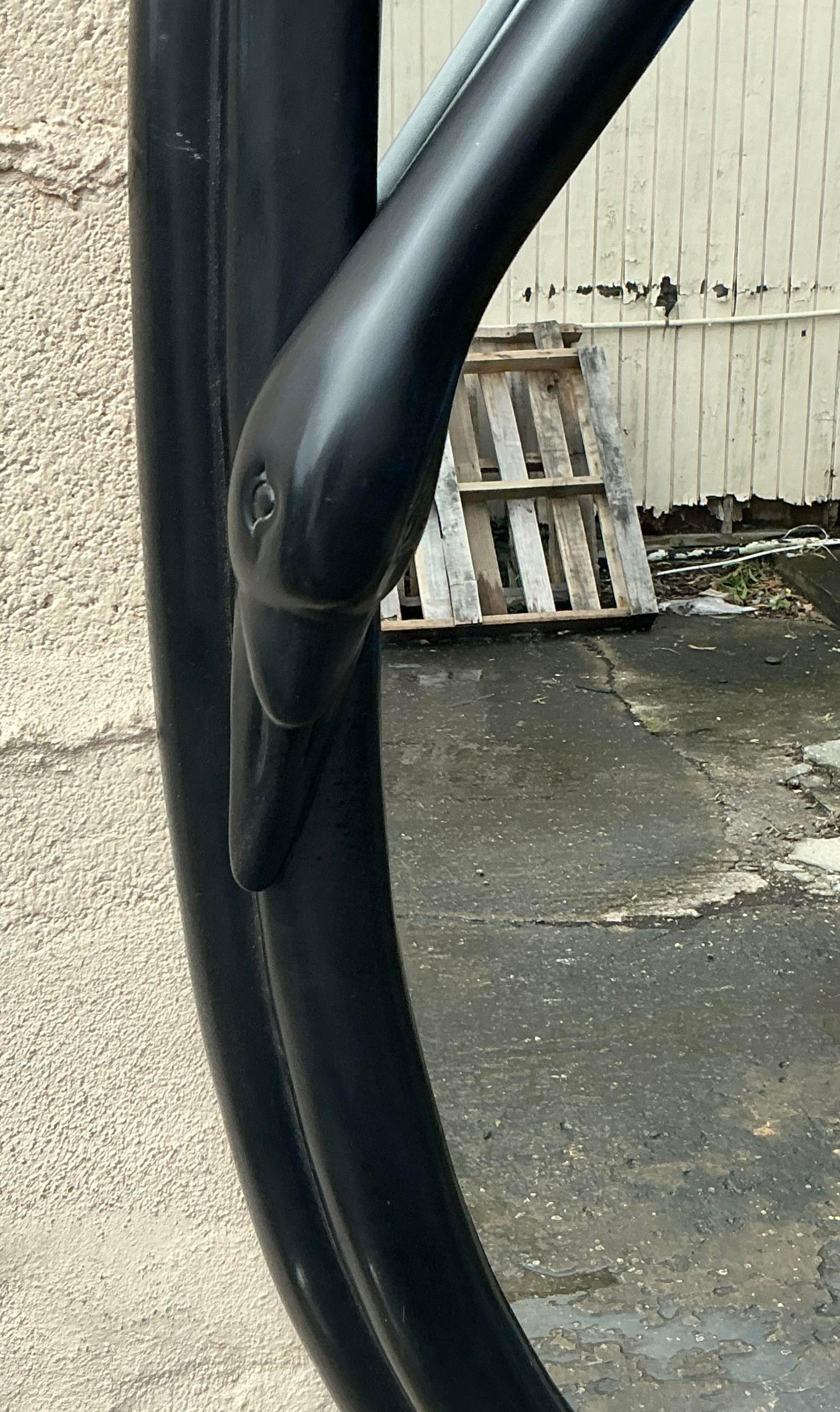 Add a touch of glamour and elegance to your space with this Vintage Deco Black Swan Mirror. Featuring a striking black swan motif, this mirror is a stunning example of Art Deco design, with sleek lines and bold, sculptural details. The rich black
