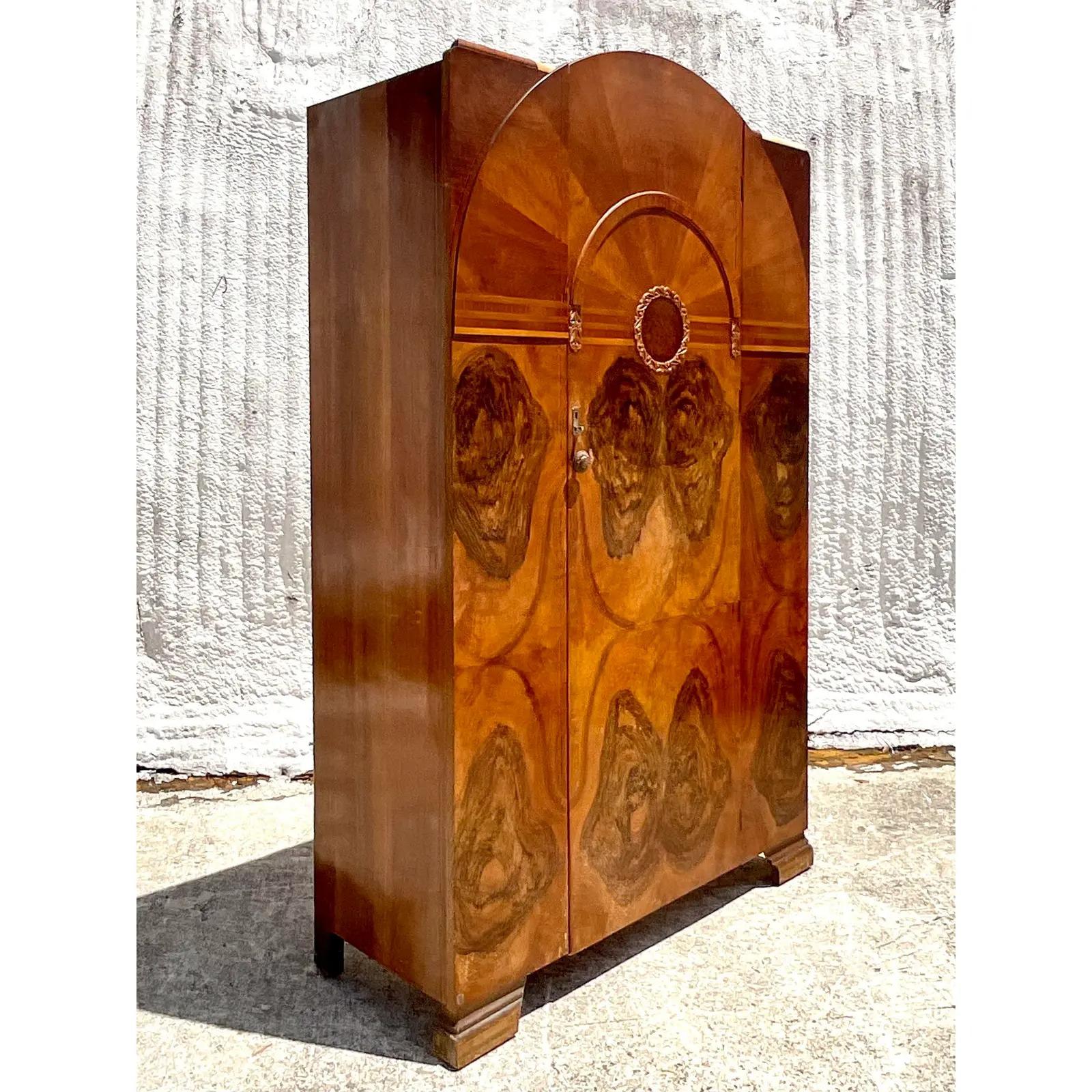 Incredible vintage Deco armoire. Beautiful wood grain detail. Two interior hang bars for your clothing. Easily reconfigured however you like. Acquired from a Palm Beach estate.