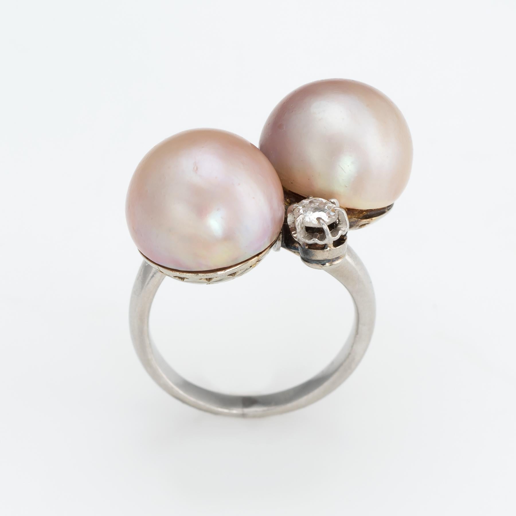 Finely detailed vintage Art Deco cultured pearl & diamond ring (circa 1920s to 1930s), crafted in 900 platinum. 

Cultured pearls each measure 12mm, accented with two estimated 0.15 carat old mine cut diamonds. The total diamond weight is estimated