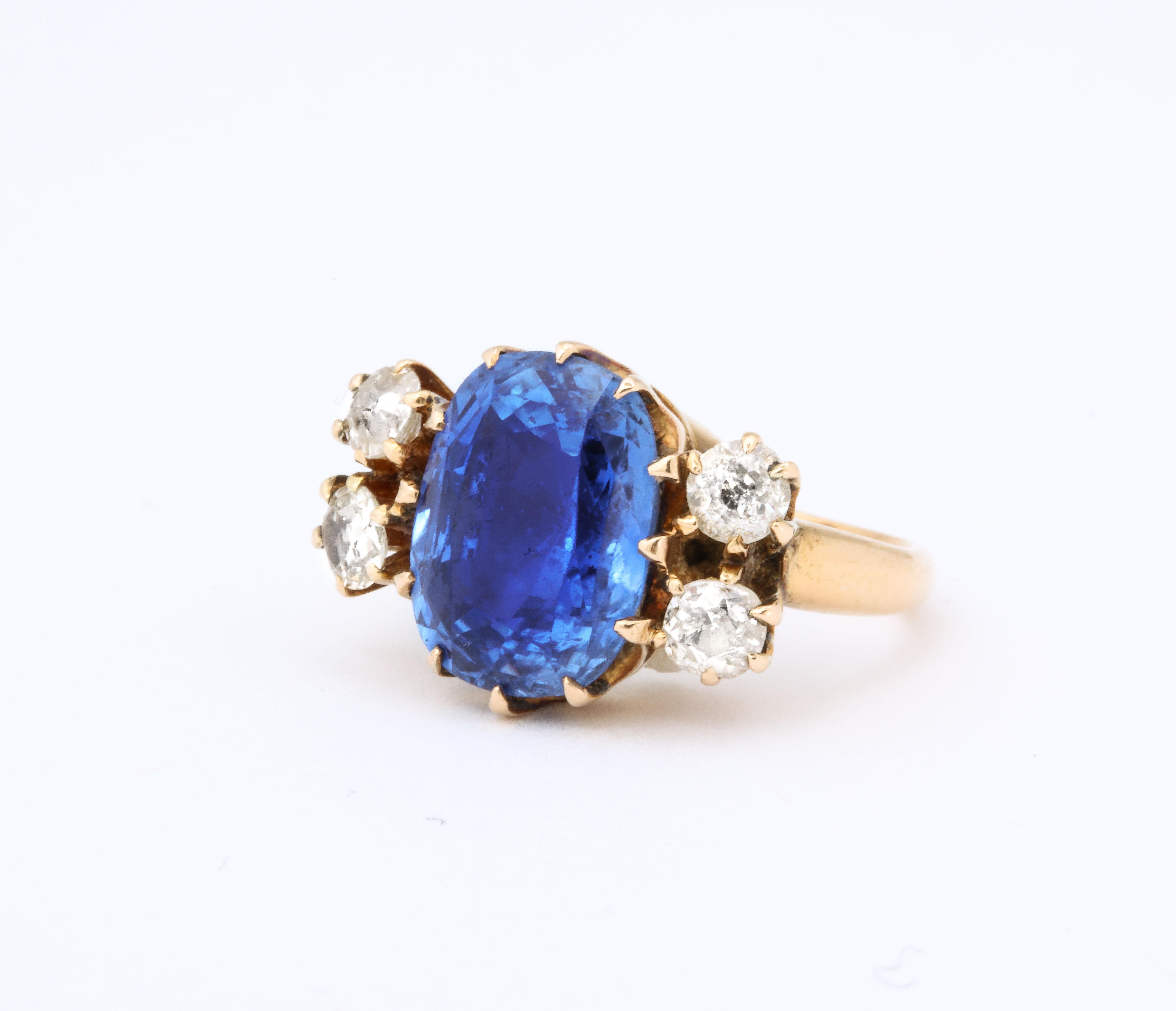 A beautiful Ceylon color Natural Sapphire set between two sets of diamonds . The Sapphire is a 9 carat oval cut.