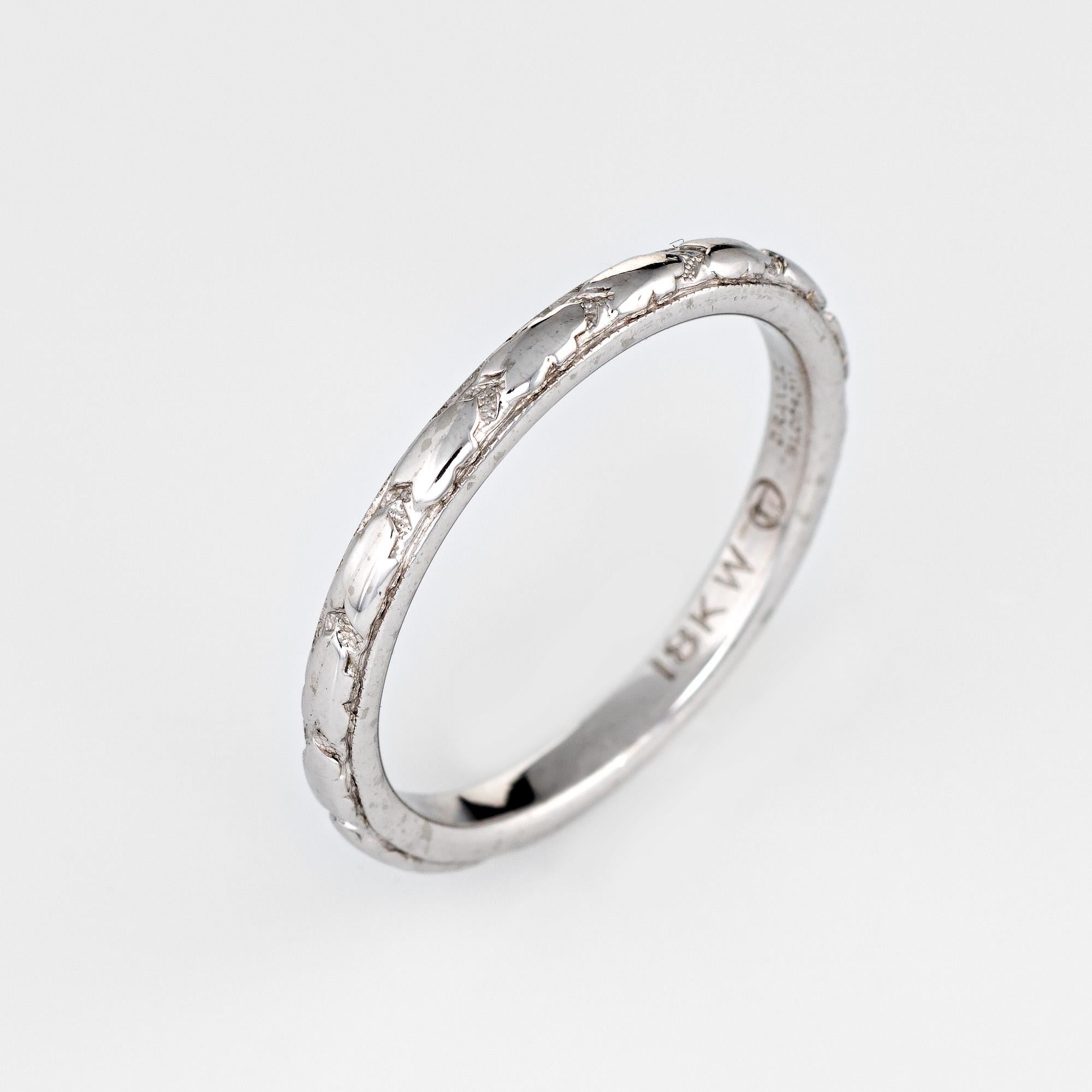 Stylish vintage Art Deco era wedding band (circa 1920s to 1930s) crafted in 18k white gold.

The ring is made by Traub of Detroit, Michigan. The orange blossom line was a popular design during the 1920s. The ring is great worn as a wedding band or