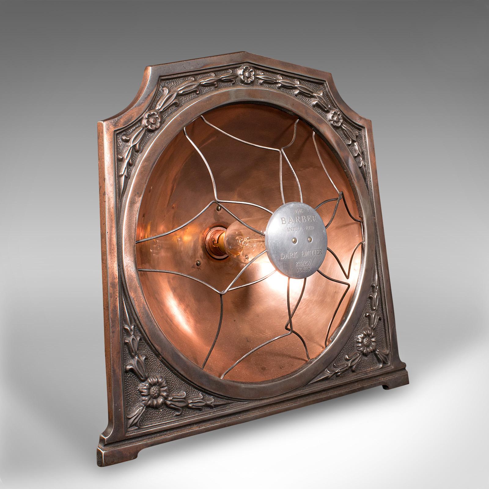 This is a vintage decorative accent lamp. An English, cast alloy and copper converted medical heat lamp, dating to the early 20th century, circa 1930.

Of fascinating form and decorative appeal, with a delightful finish
Displays a desirable aged