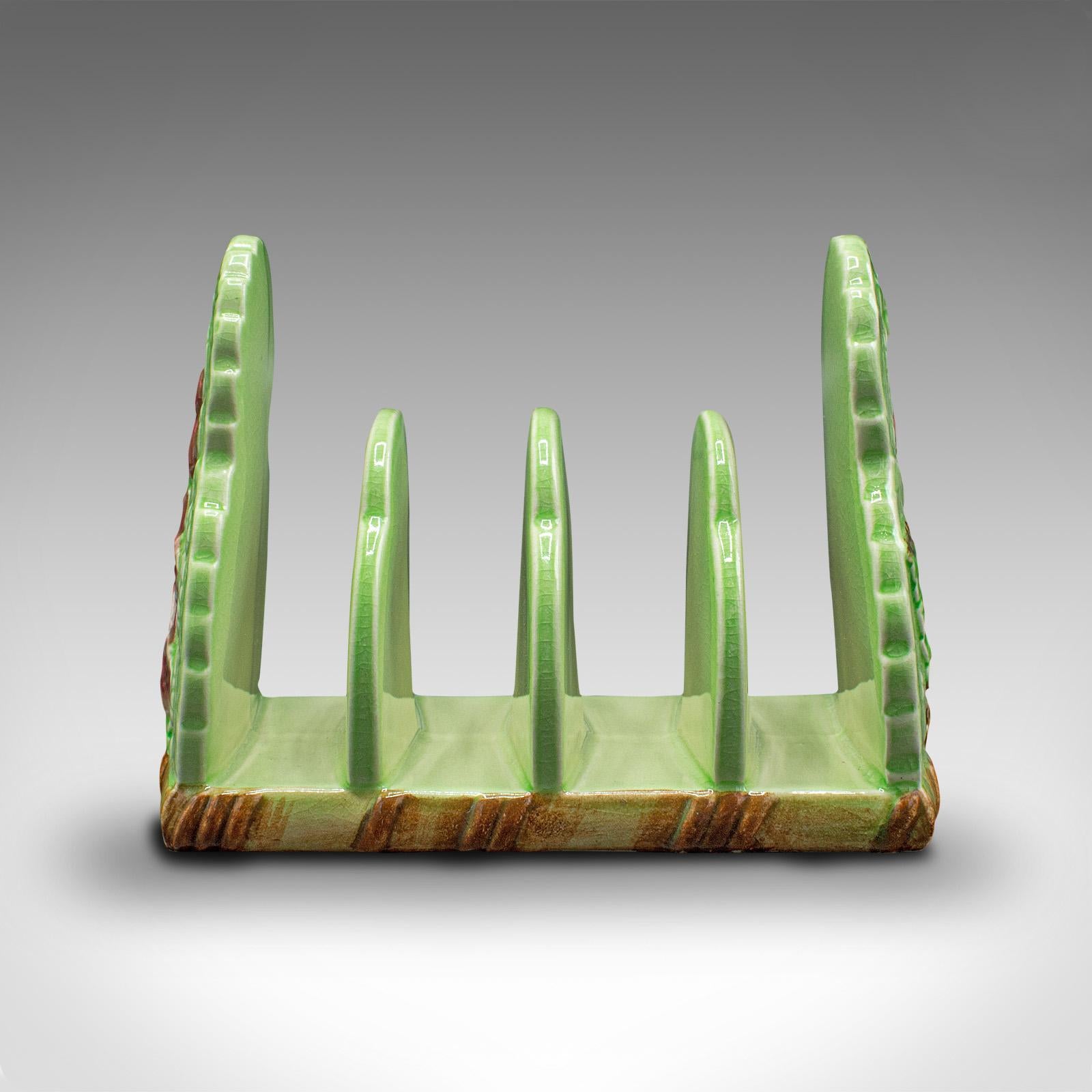 This is a vintage decorative breakfast stand. An English, ceramic 4-slot toast rack, dating to the mid 20th century, circa 1940.

Grace the breakfast table with a splash of charming colour 
Displaying a desirable aged patina in good original