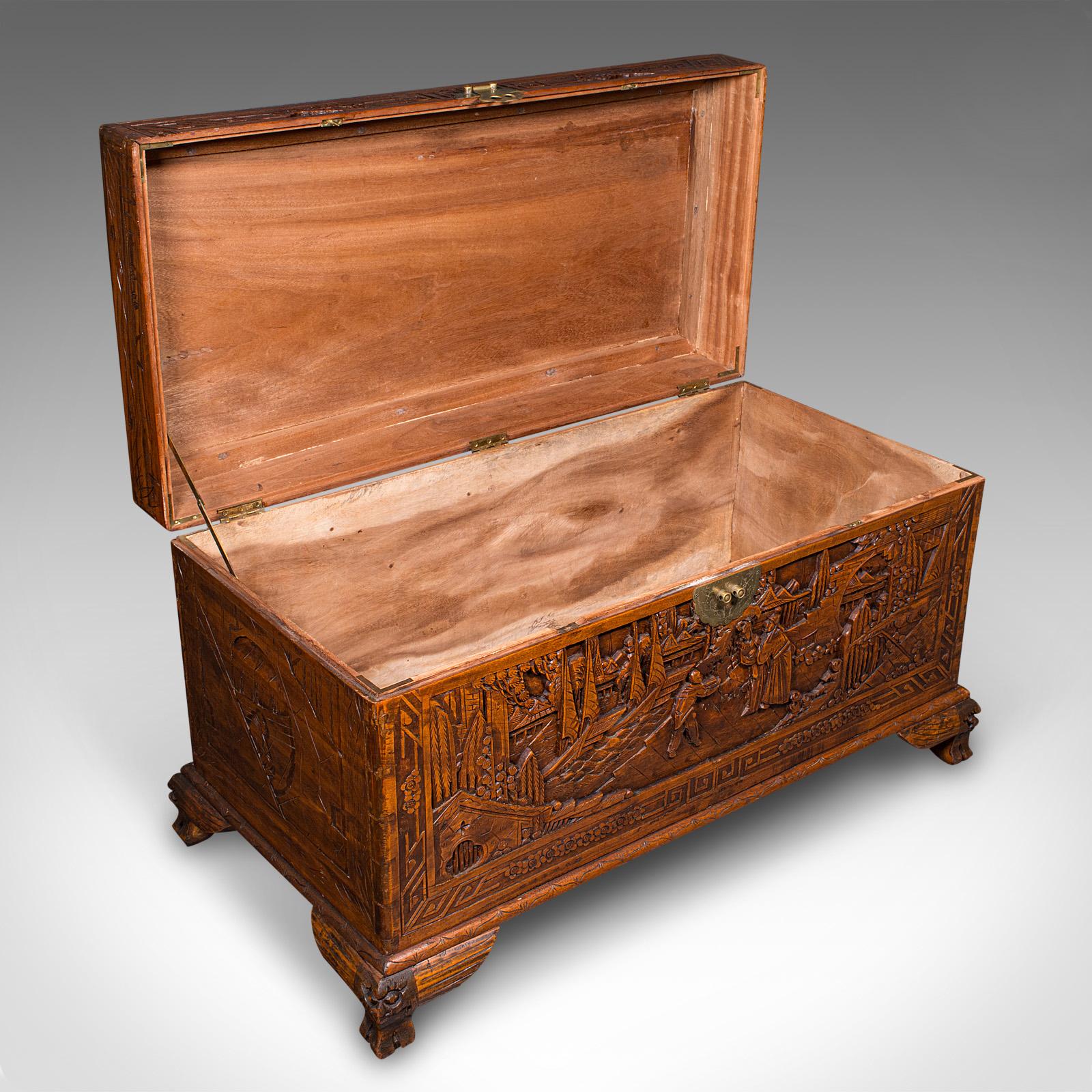 
This is a large vintage decorative carved chest. A Chinese, camphorwood and brass linen trunk with Art Deco taste, dating to the mid 20th century, circa 1940. 

Profusely carved to each fascia and of substantial proportion
Displays a desirable aged