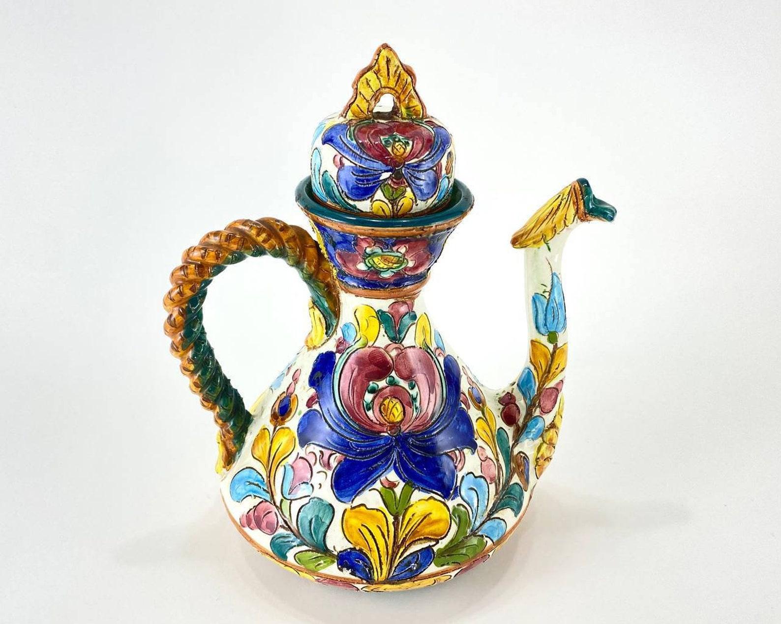 German ceramic kettle from the famous manufacturer Assbrock Keramik Majolika handmade with a pattern of multi-colored flowers and leaves, painted in pink, blue, brown, green and white. 

 Gift of ceramic jug will delight your friends and family.