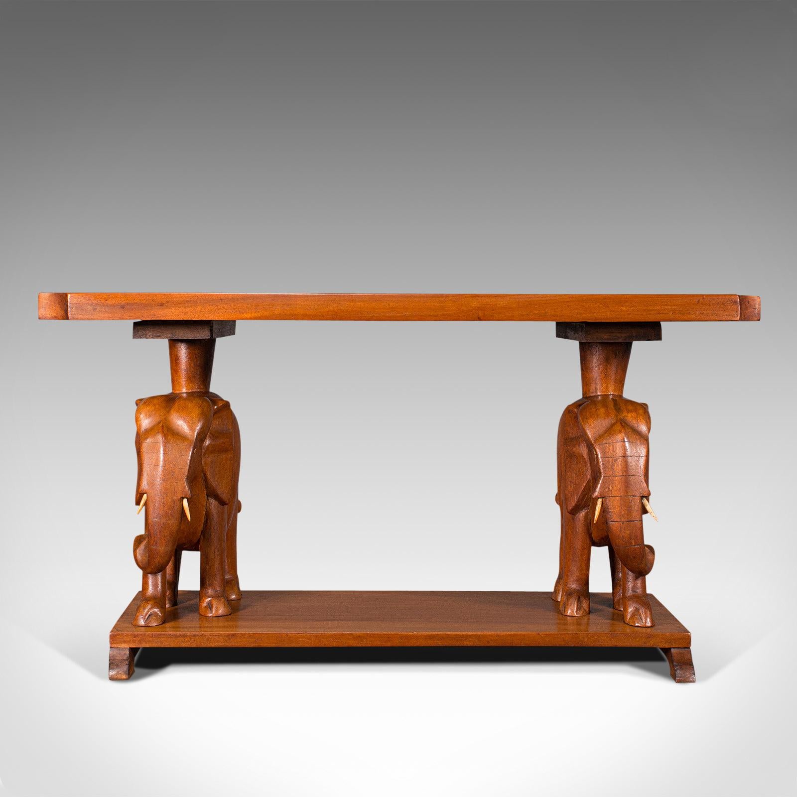 This is a vintage decorative coffee table. An Asian, mahogany side table with elephant figures, dating to the late Art Deco period, circa 1940.

Offering great character and rich colour for the living room
Displays a desirable aged patina and in