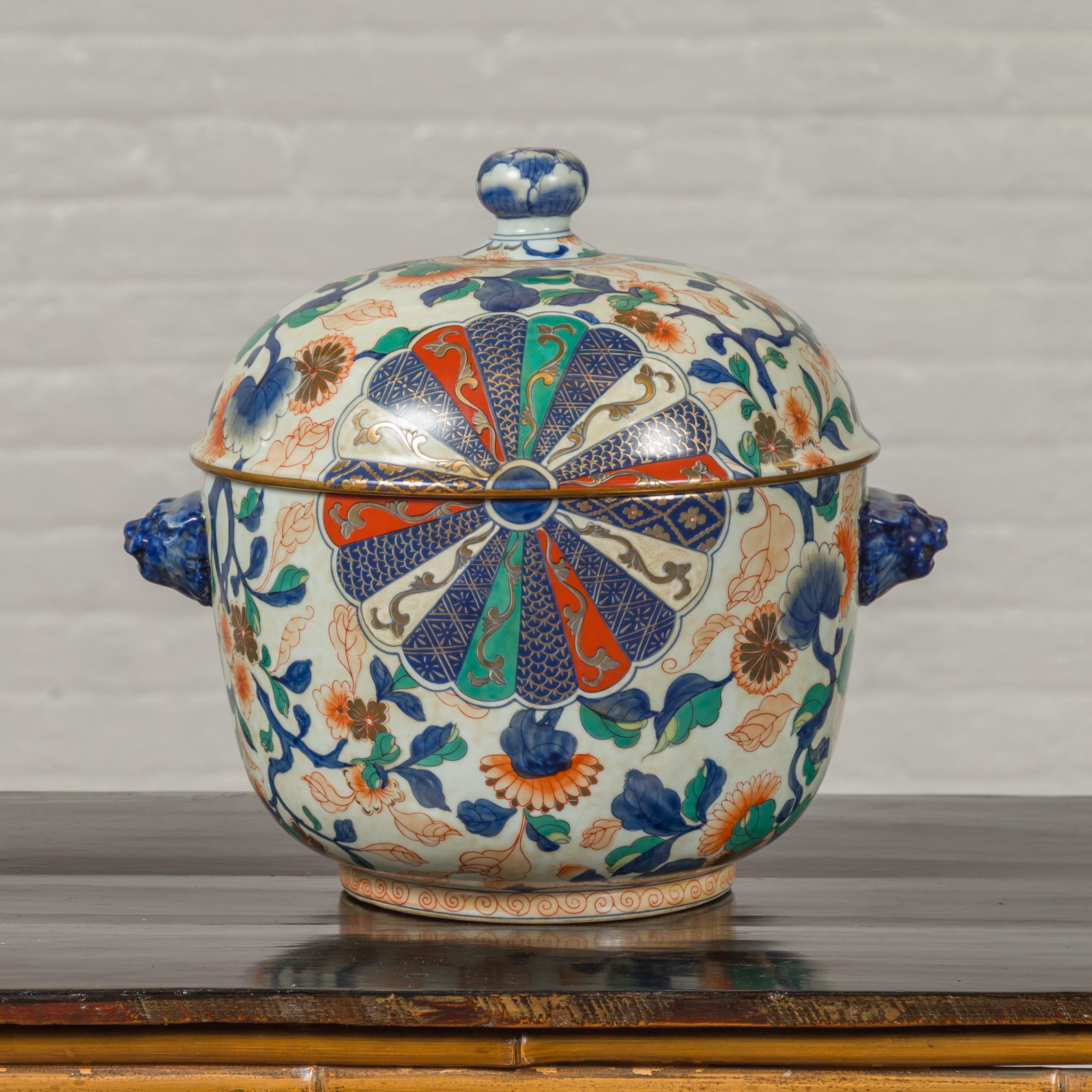 A vintage decorative covered soup tureen from the mid-20th century, with hand painted polychrome decor. Created in Taiwan and hand painted in Hong Kong, this soup tureen captures our attention with its radiating patterns and colorful décor made of