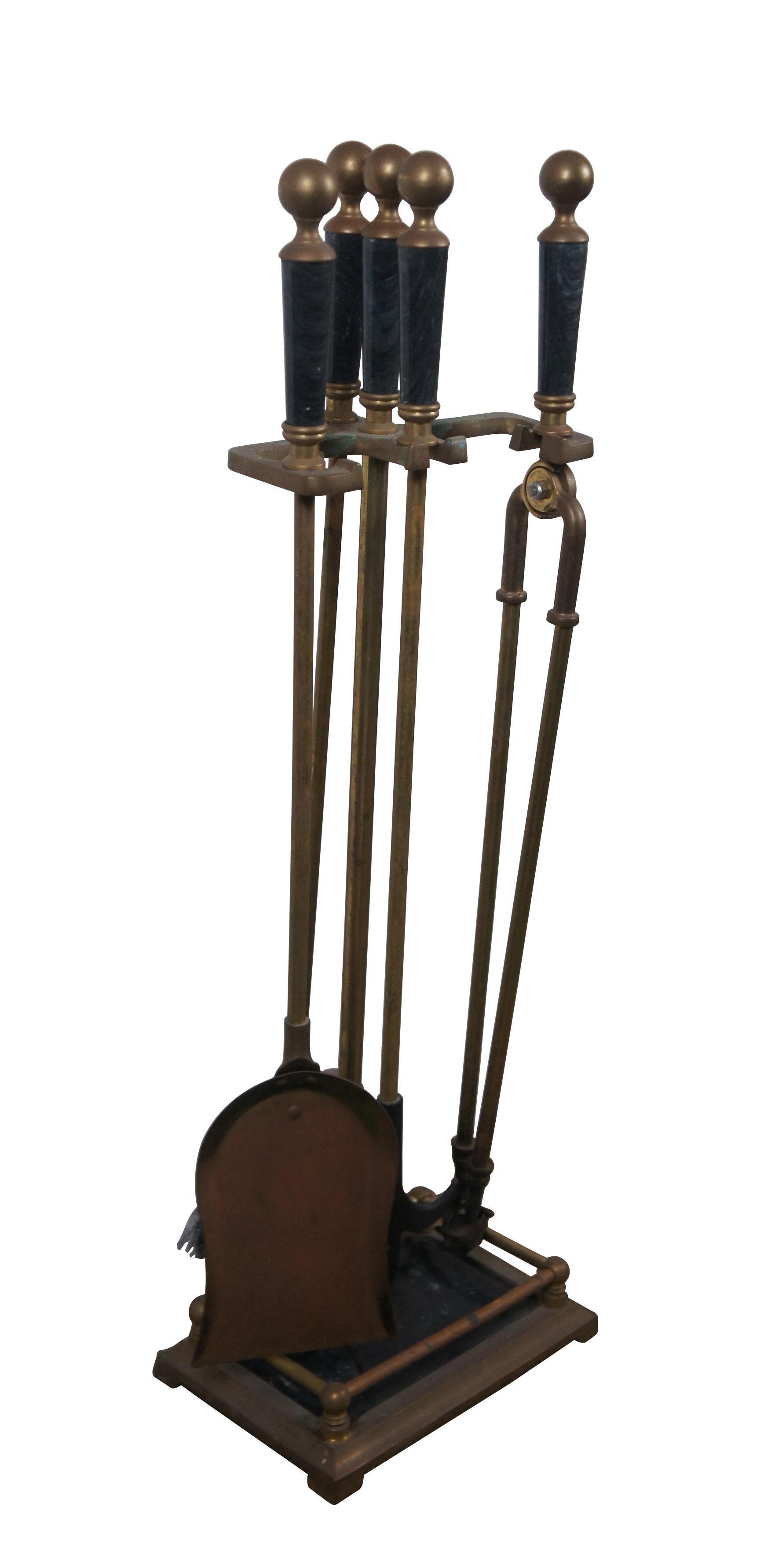 Mid to late 20th century five piece set of fireplace / hearth tools and stand by Decorative Crafts Inc, item number 2921. Made of brass with black marble base and tool grips with round finials. Set includes stand, shovel, poker, tongs, and