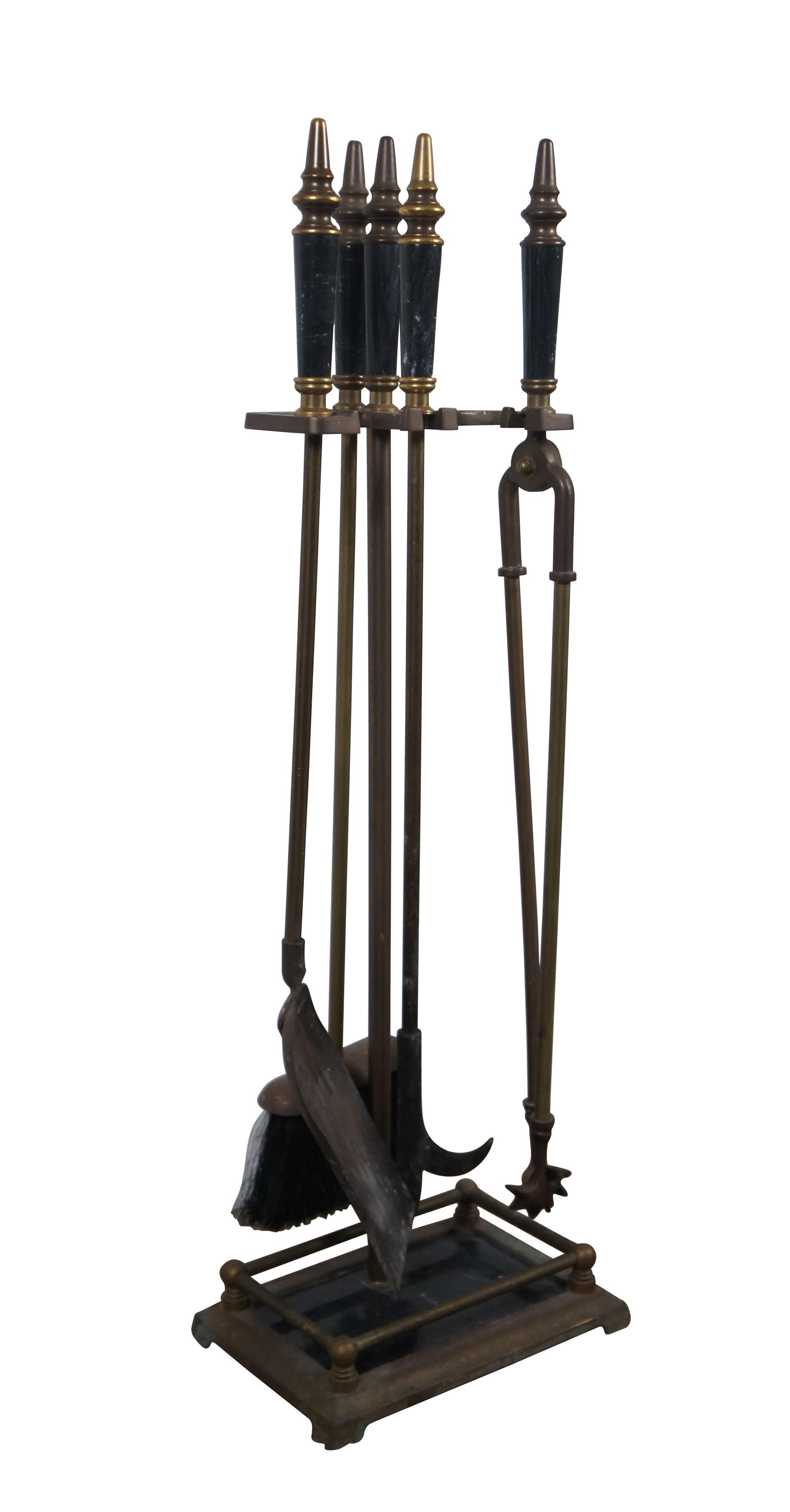 Mid to late 20th century five piece set of fireplace / hearth tools and stand by Decorative Crafts Inc, item number 2924. Made of brass with black marble base and tool grips with turned conical finials. Set includes stand, shovel, poker, tongs, and
