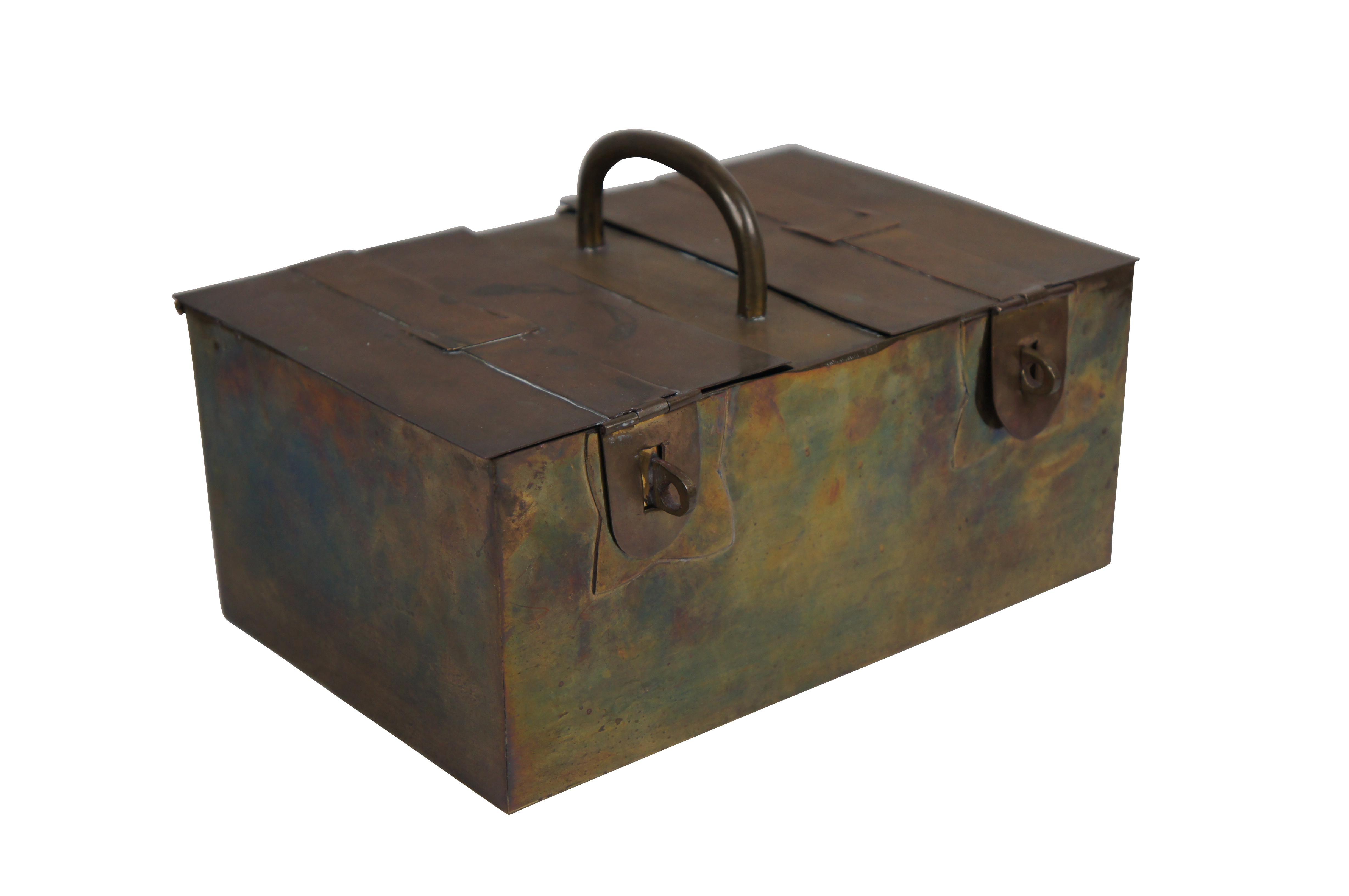 Vintage Decorative Crafts Inc hand crafted brass strong box / lock box. Rectangular form with fixed handle at center of top, two hinged lids with padlock hasps and decorative imitation straps, and single interior compartment. Made in