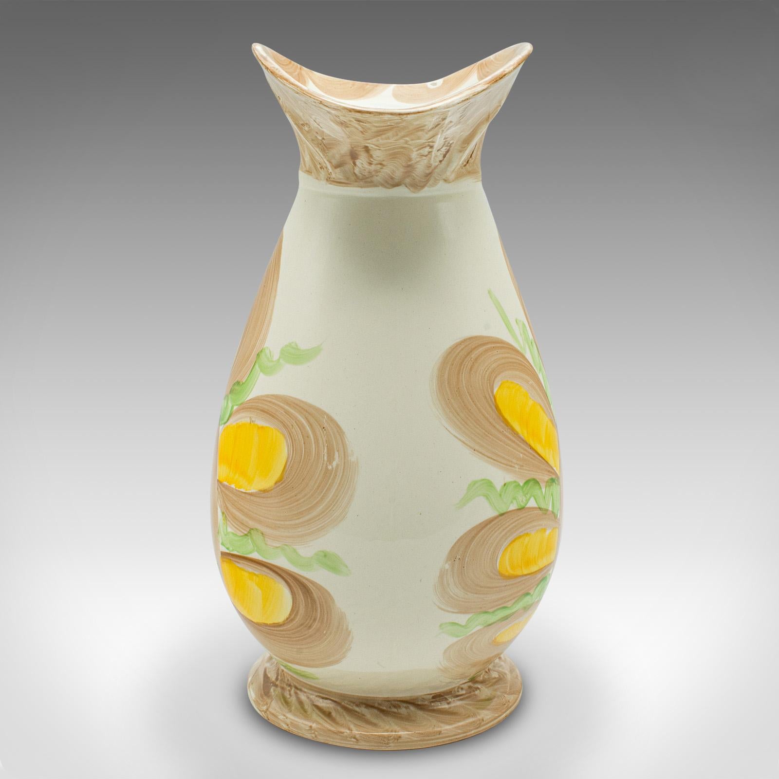 
This is a vintage decorative creamer jug. An English, hand painted ceramic milk pourer in Art Deco taste, dating to the early 20th century, circa 1930.

Charmingly decorative creamer with great hand painted colour
Displaying a desirable aged patina