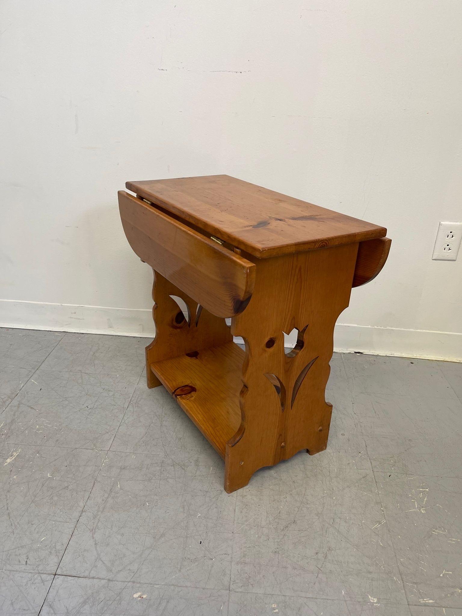 Side Table with one Lower lower shelf. Drop leaf decorative, does not go up. Carved Tulip on two ends. Vintage Condition Consistent with Age as Pictured.

Dimensions. 22 W ; 1 D ; 22 H