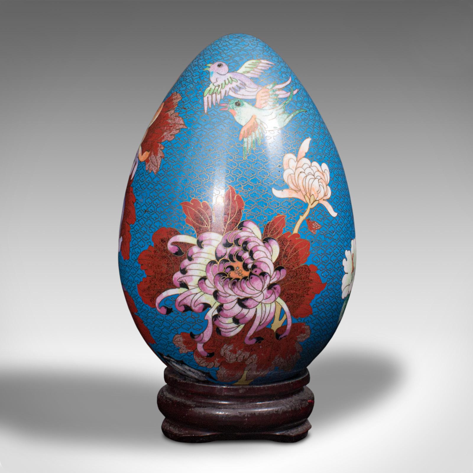 This is a vintage decorative egg. A Chinese, cloisonné ornament, dating to the Art Deco period, circa 1940.

Colourful example of vintage cloisonné and impressive at nearly a foot tall on stand
Displays a desirable aged patina and in good