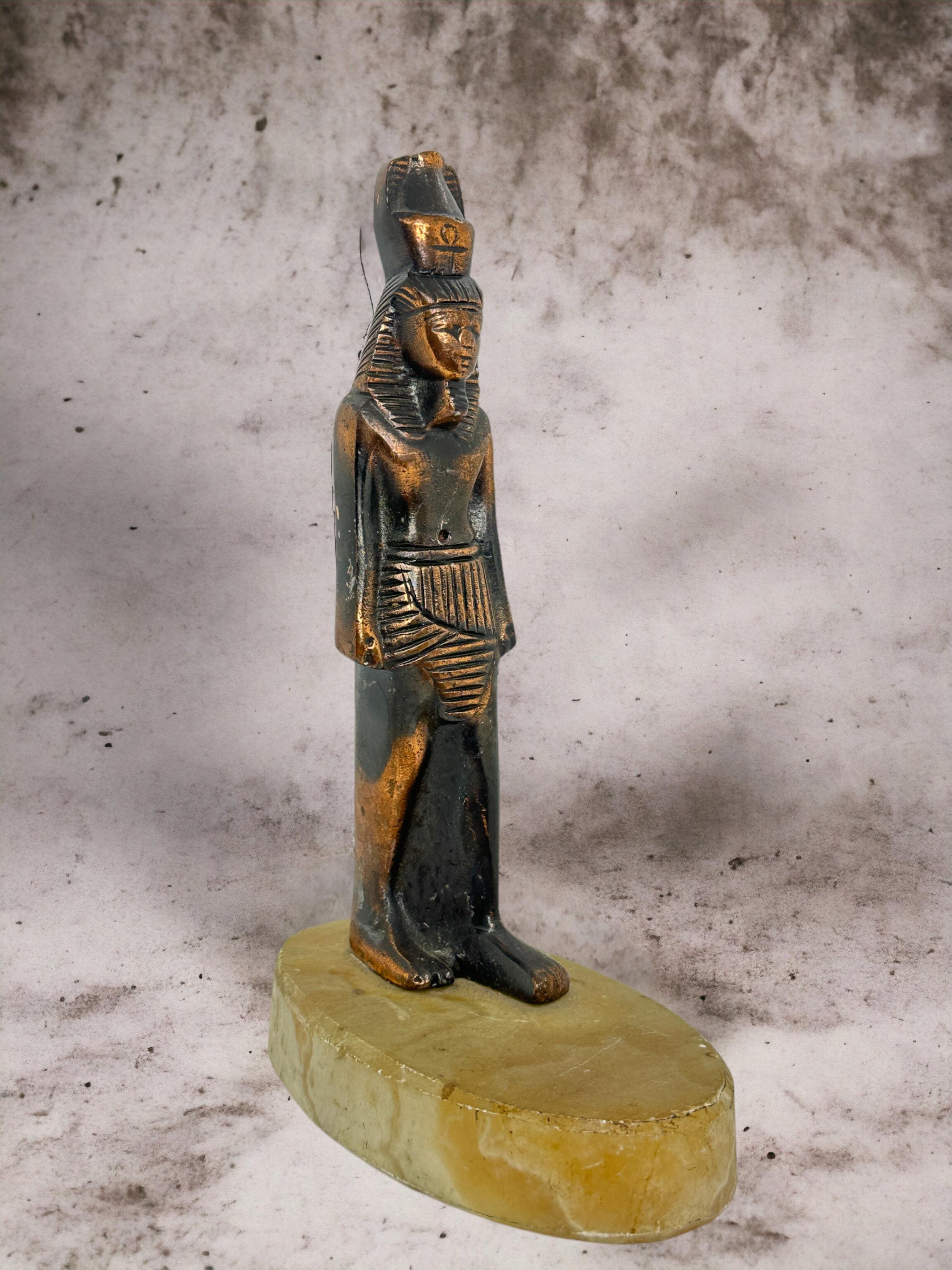 A beautifully crafted statue of an ancient Egyptian pharaoh, I believe it is Ramses the 2nd however I am not completely sure. The statue appears to be made of copper or white metal. It is fixed to an alabaster base.
A stunning piece of home decor