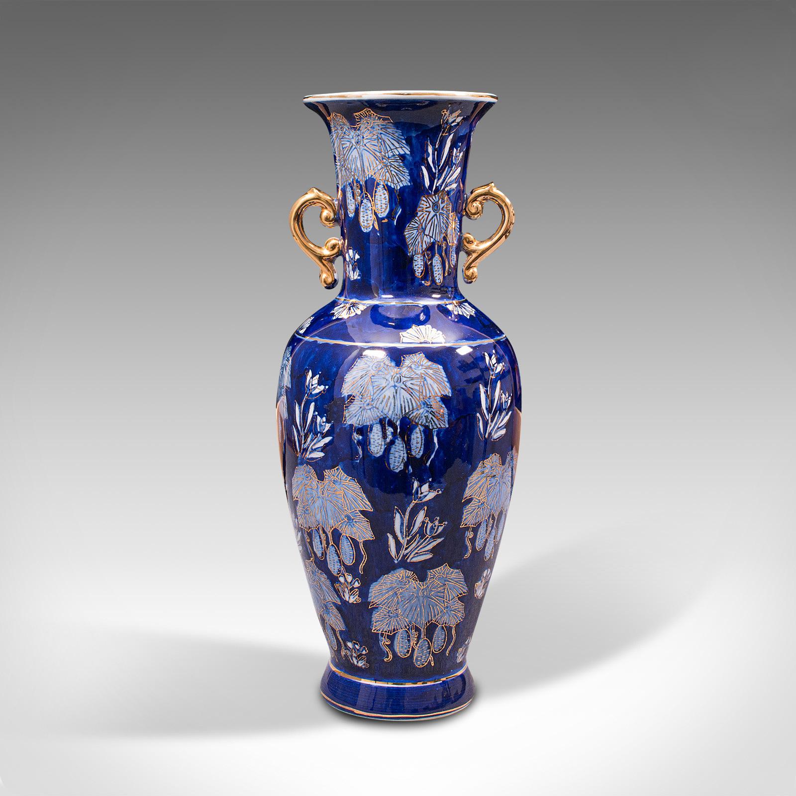 This is a vintage decorative flower vase. An Oriental, ceramic ornamental baluster urn, dating to the late 20th century, circa 1980.

Rich cobalt colour with eye-catching decoration
Displaying a desirable aged patina and free of marks or