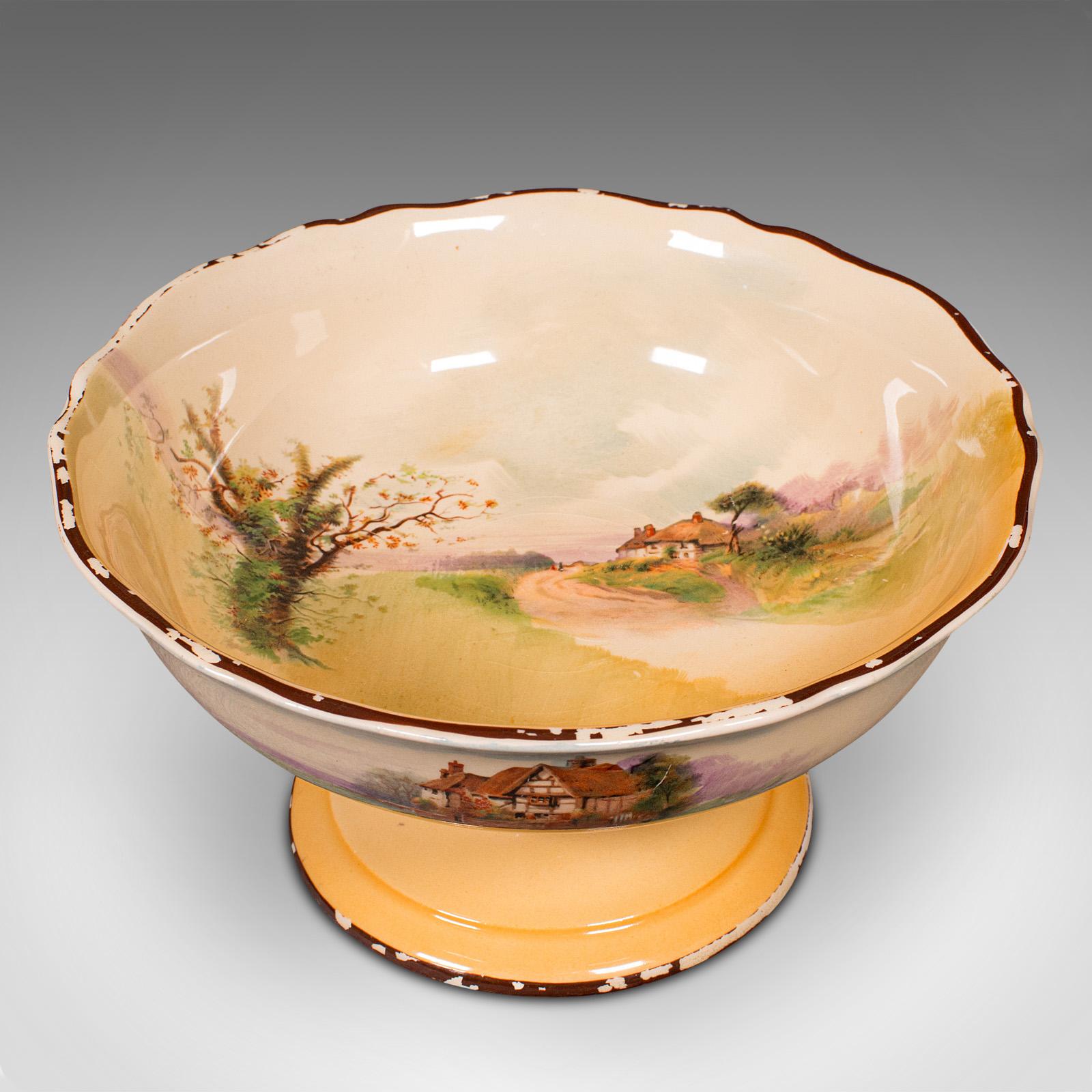 This is a vintage decorative footed bowl. An English, ceramic serving dish, dating to the early 20th century, circa 1930.

Delightful landscape scenes with traditional English country side appeal
Displays a desirable aged patina in good original