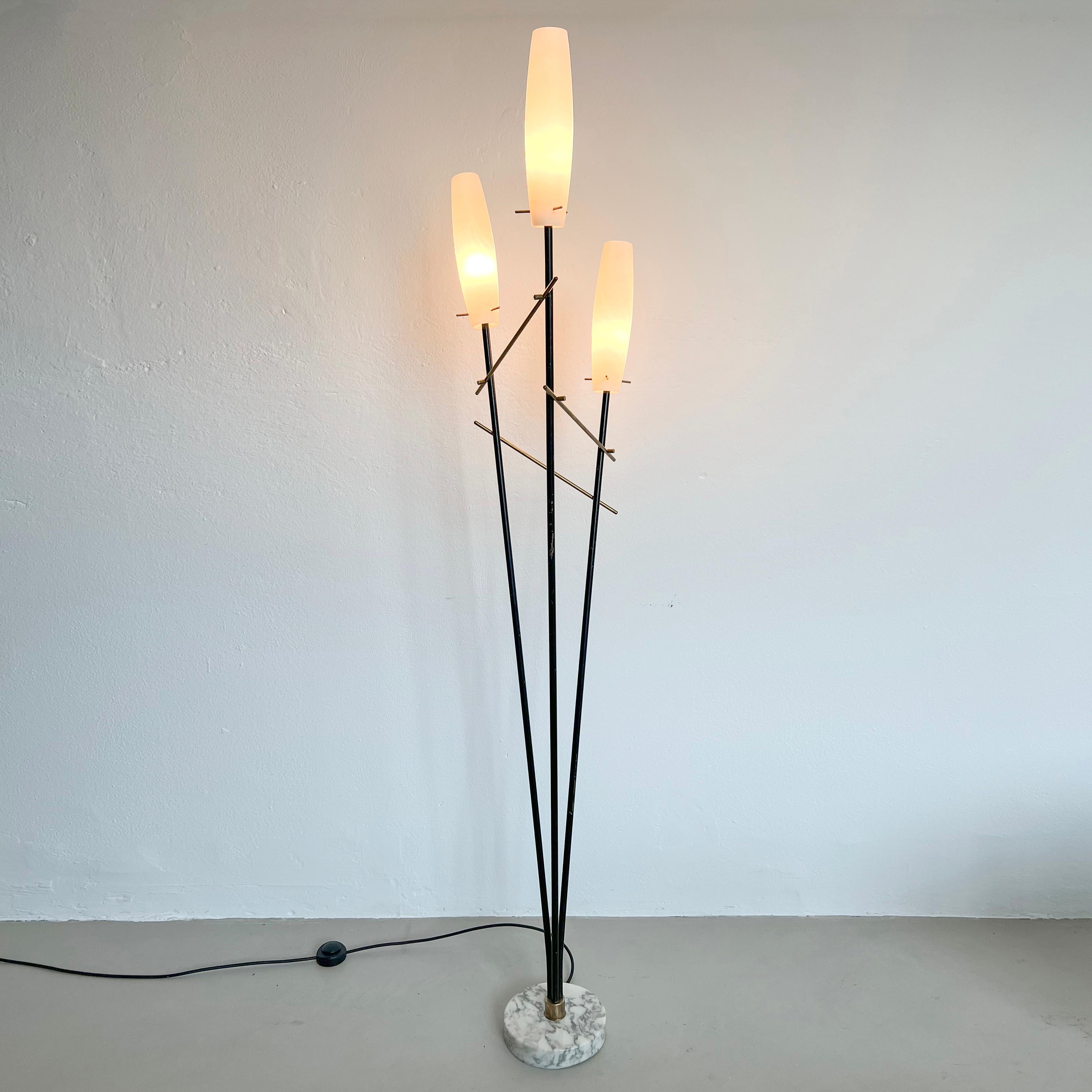 Vintage Italian floor Lamp of the 50's , timeless design & very Decorative 

Offered for sale is a vintage floor lamp, made in Italy in the 1950s. It's crafted from metal and brass and has a round white marble base with a nice texture. It has three