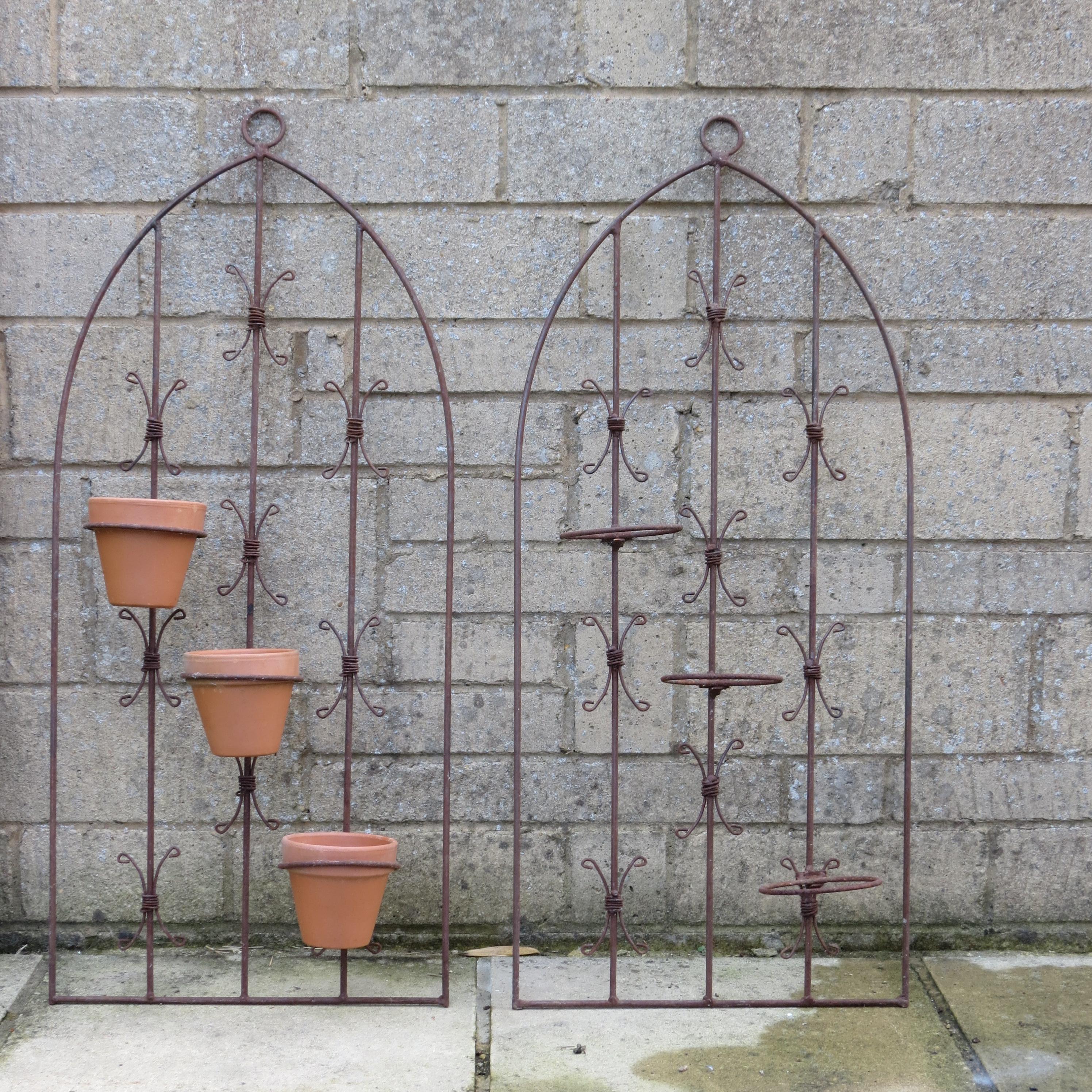 Wonderful vintage metal wall hanging planter. Very decorative piece, dates from the late 20th Century. Very nice quality, made from steel rod, with newly replaced terracotta pots. 

2 identical wall hanging planters available
Each plant pot fits