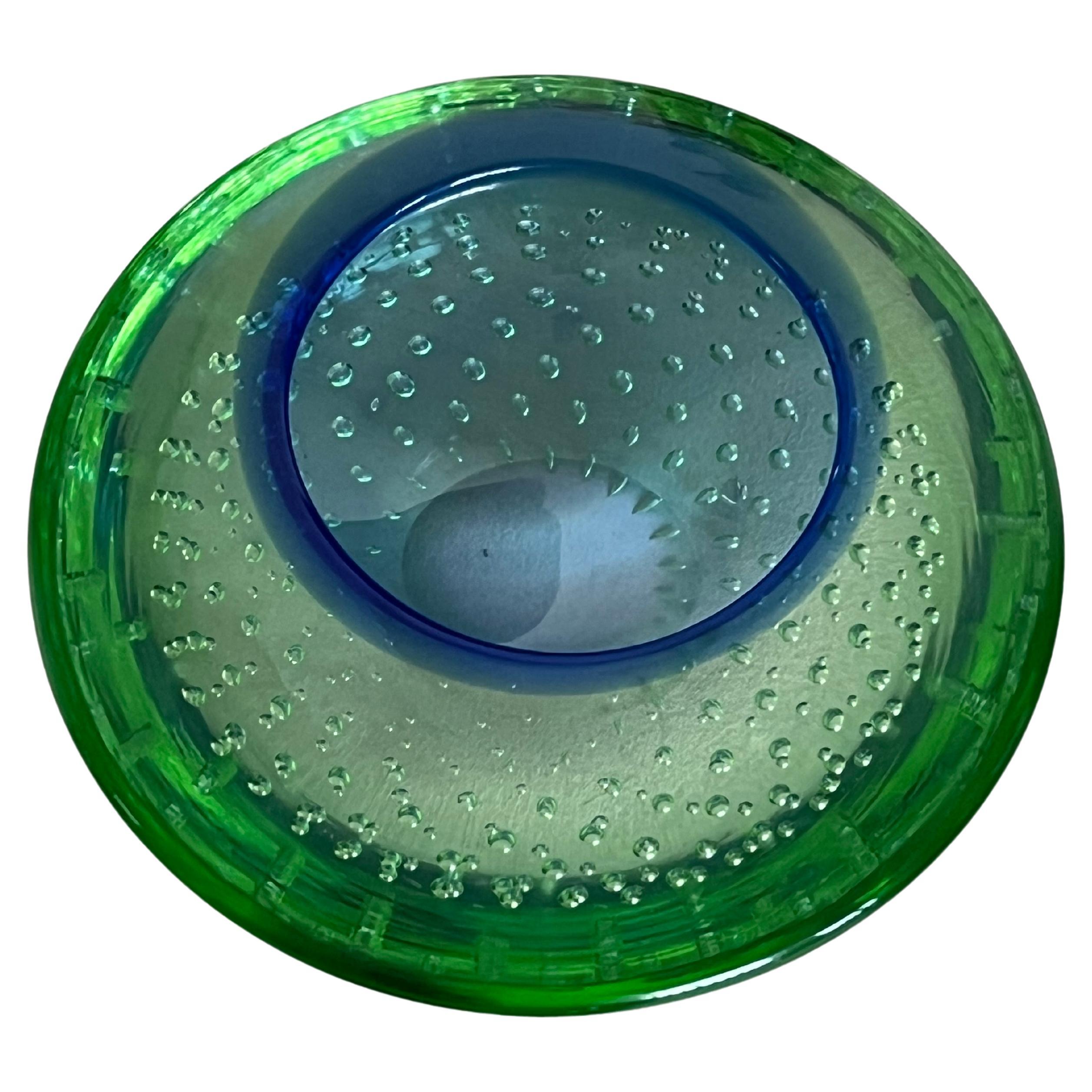 Vintage decorative Murano bowl/ashtray in green and blue “Sommerso” glass with included bubbles.

Highly collectible, mesmerizing and timeless, Murano glass is one of the most fascinating materials in the world. Used since the 14th century to create